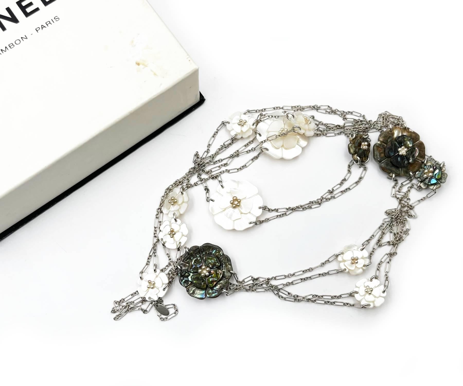 Chanel Super Rare Vintage White Grey Mother of Pearl Camellia Silver Chain Super Long Necklace

*Marked 98
*Made in France
*Comes with the original box

-It is approximately 58″ long.
-The pendant is approximately 1.25″ x 1.25″ and 0.75″ x