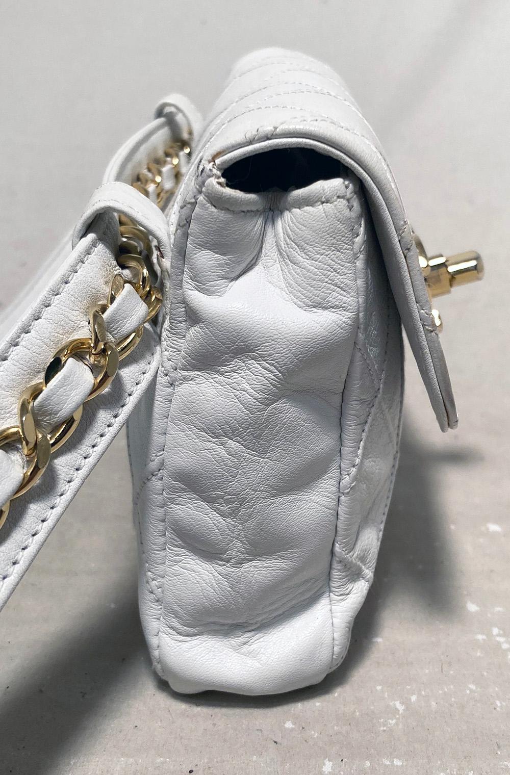 Chanel Vintage White Leather Belt Bag in excellent condition. Quilted white leather exterior trimmed with gold hardware. CC twist logo closure opens to a matching white leather interior with one side zipped pocket. Clean corners edges and interior.