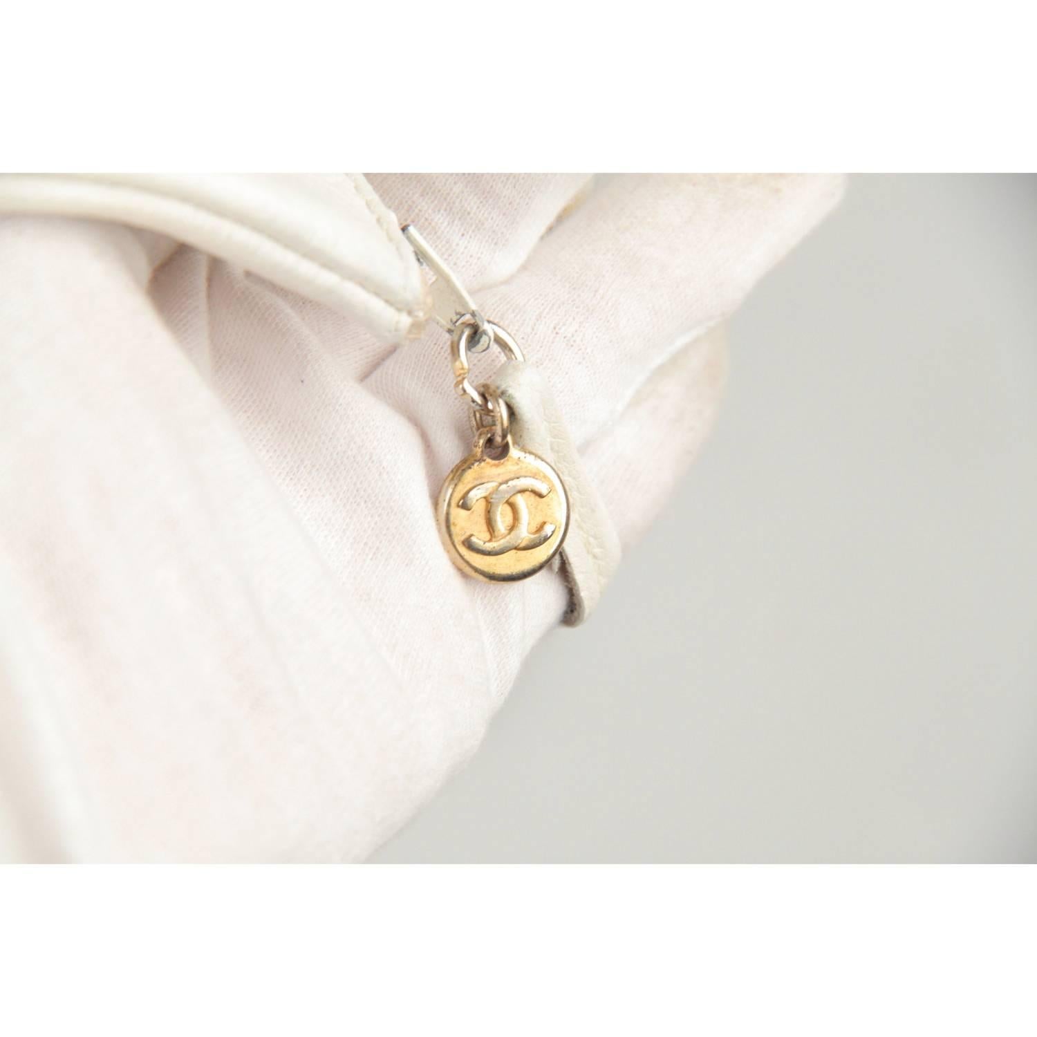 - Classic vintage drawstring/bucket by CHANEL
- Period/Era: 1989 to 1991
- Big CC - CHANEL logo on the front
- Drawstring closure on top
- Gold-metal eyelets
- interwoven leather heavy chain strap
- Leather interior
- Internal zip pouch

Logos &