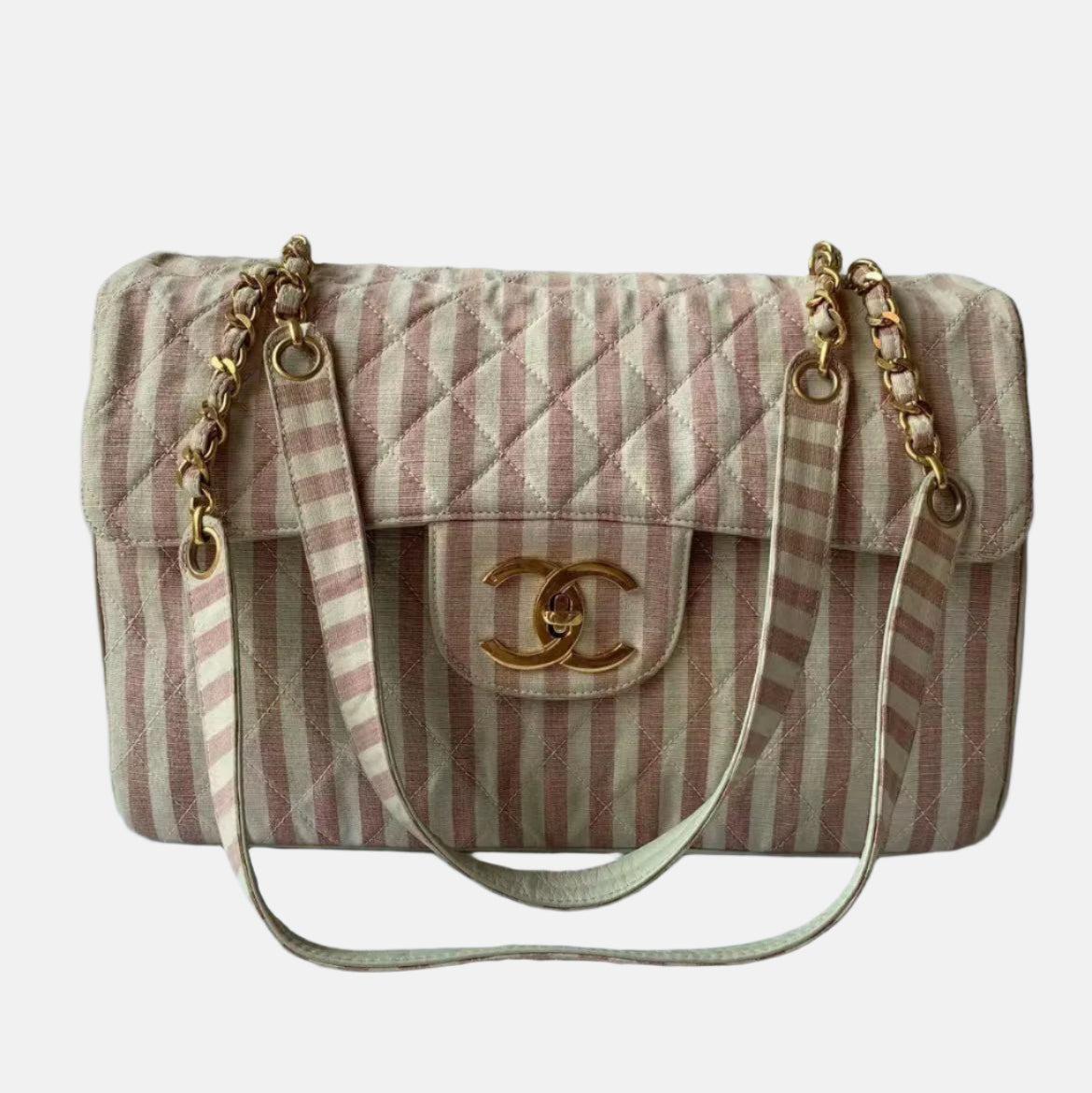 Chanel Vintage XXL Maxi Pink Striped Travel Flap Bag Canvas Gold Hardware
 These are professional photos of the actual bag .
 
 
 
 
 
 
 CONDITION: VERY GOOD CONDITION
 
 This previously owned and used item is in good condition with light signs of