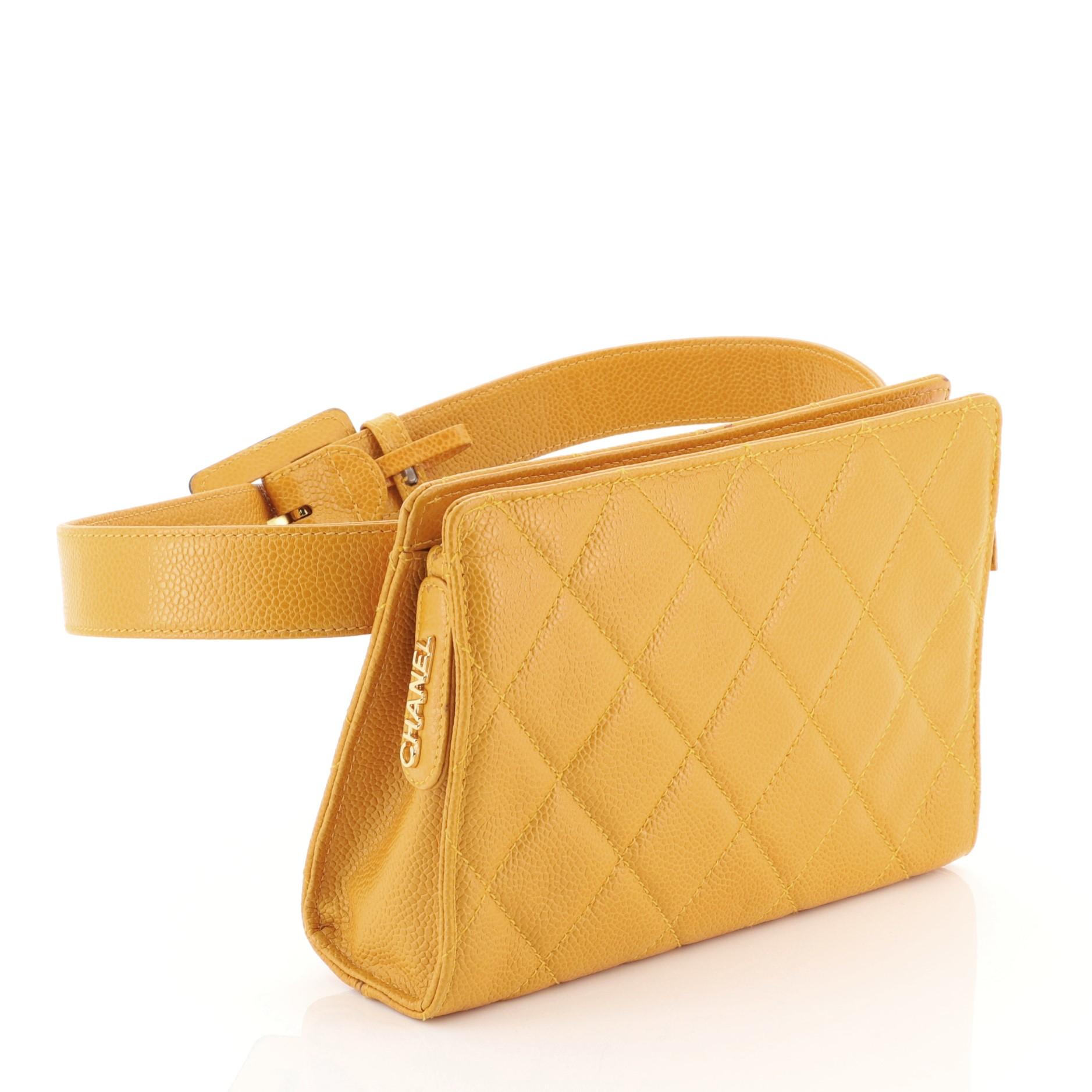 This Chanel Vintage Zip Belt Bag Quilted Caviar Small, crafted in yellow quilted caviar leather, features an adjustable leather belt strap and gold-tone hardware. Its zip closure opens to a neutral fabric interior. Hologram sticker reads: 4108318.