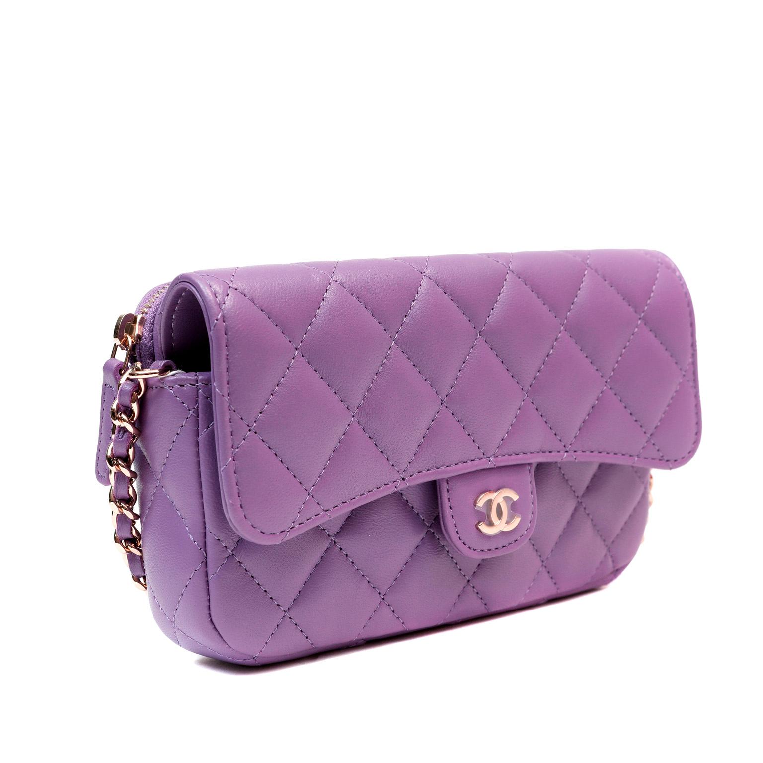 This authentic Chanel Violet Lambskin WOC is in pristine unworn condition.  The Wallet on a Chain is an extremely versatile piece for any collection.  It easily carries currency, coins and cards for day or evening.  Striking violet lambskin is