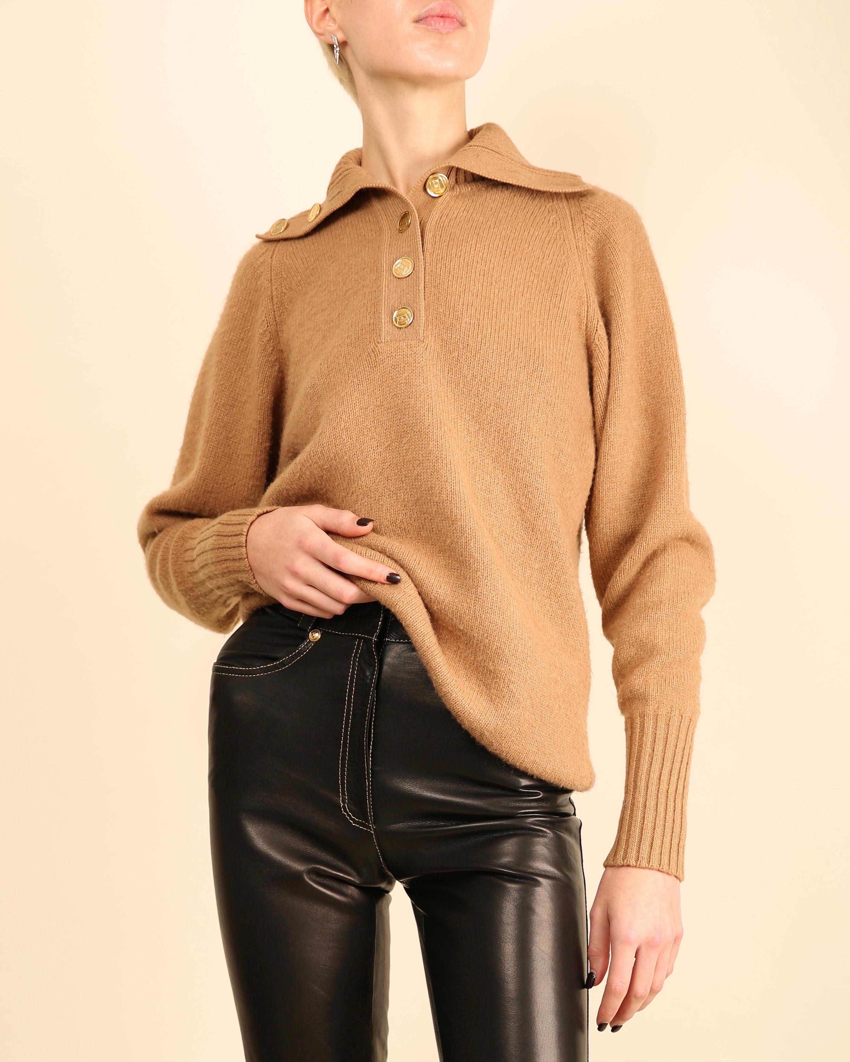 LOVE LALI Vintage

Chanel vintage cashmere oversized sweater in camel
Beautiful oversized gold buttons engraved with a Chanel handbag with a CC logo
Open turtleneck style collar that can be worn undone or fully buttoned 
Ribbed collar, hemline and