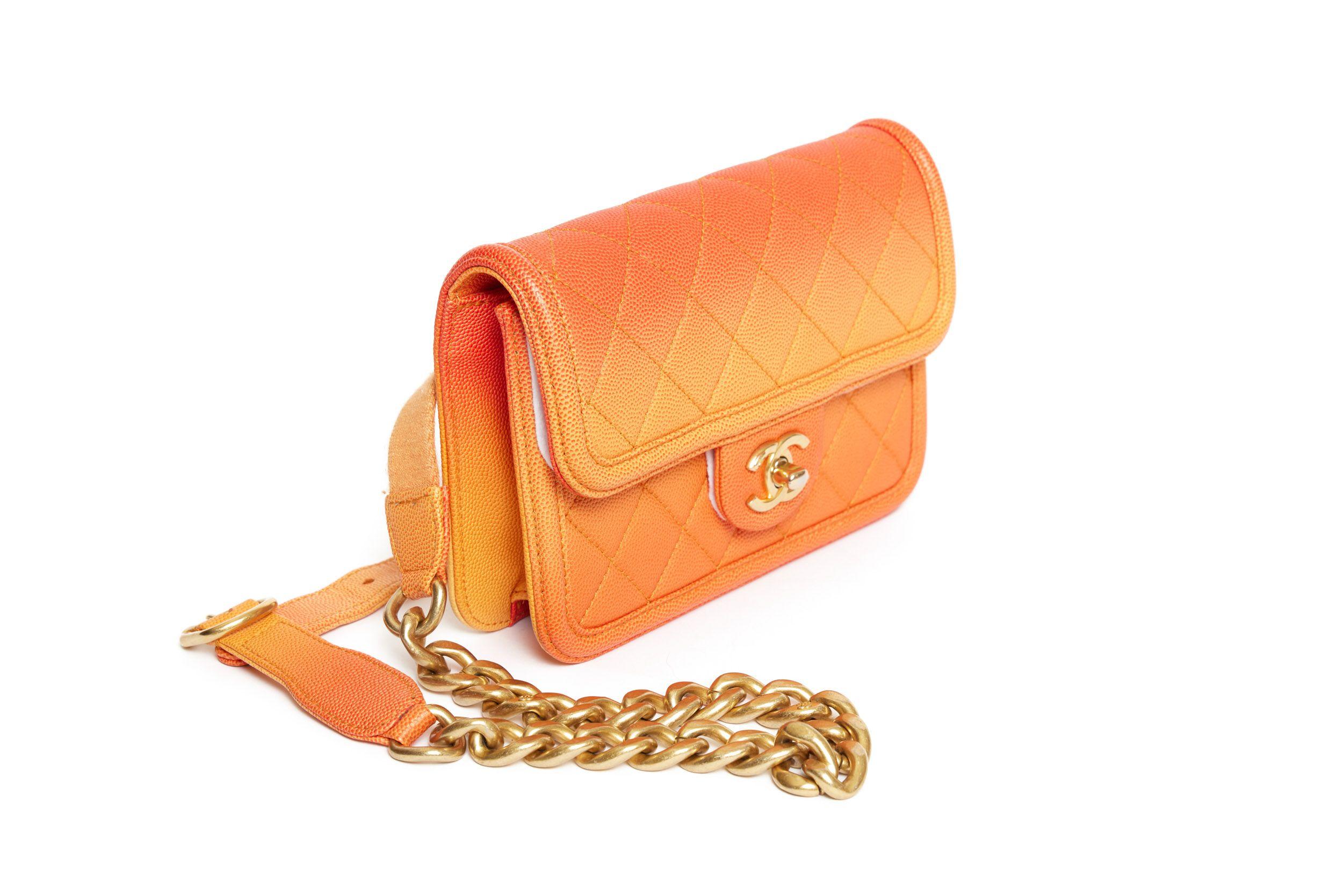 Chanel Waist Boy Bag in orange from the 2019 cruise collection. The year code is 27. The belt is 95' and it's a gold chain with little CC logos on it. The hardware of the bag is gold as well. The interior is fabric and has one zip pocket. The bag is