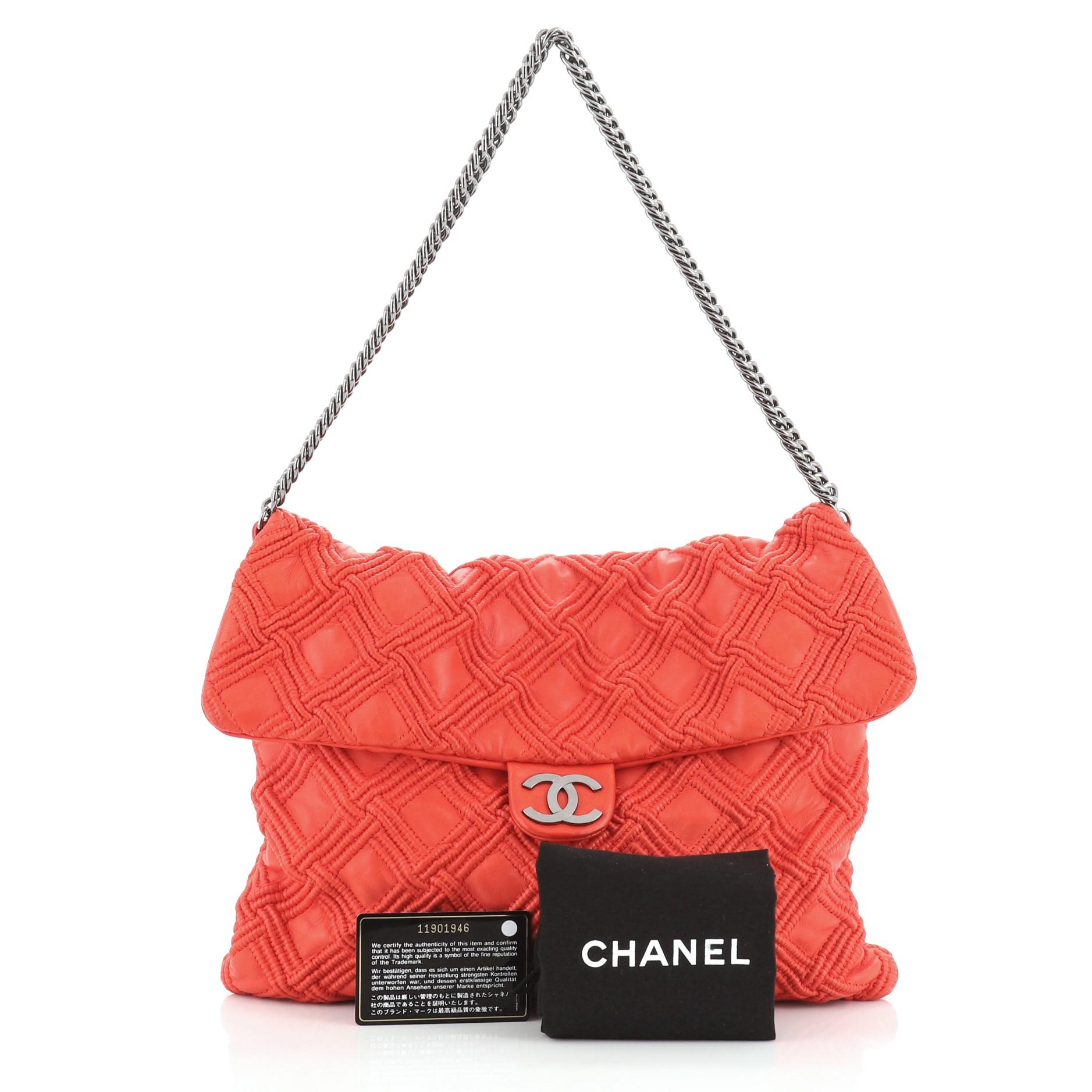 This Chanel Walk of Fame Flap Bag Stitched Lambskin Large, crafted in red smocked stitch quilted lambskin leather, features bijoux chain strap, metal CC logo and gunmetal-tone hardware. Its magnetic snap button closure opens to a grey fabric