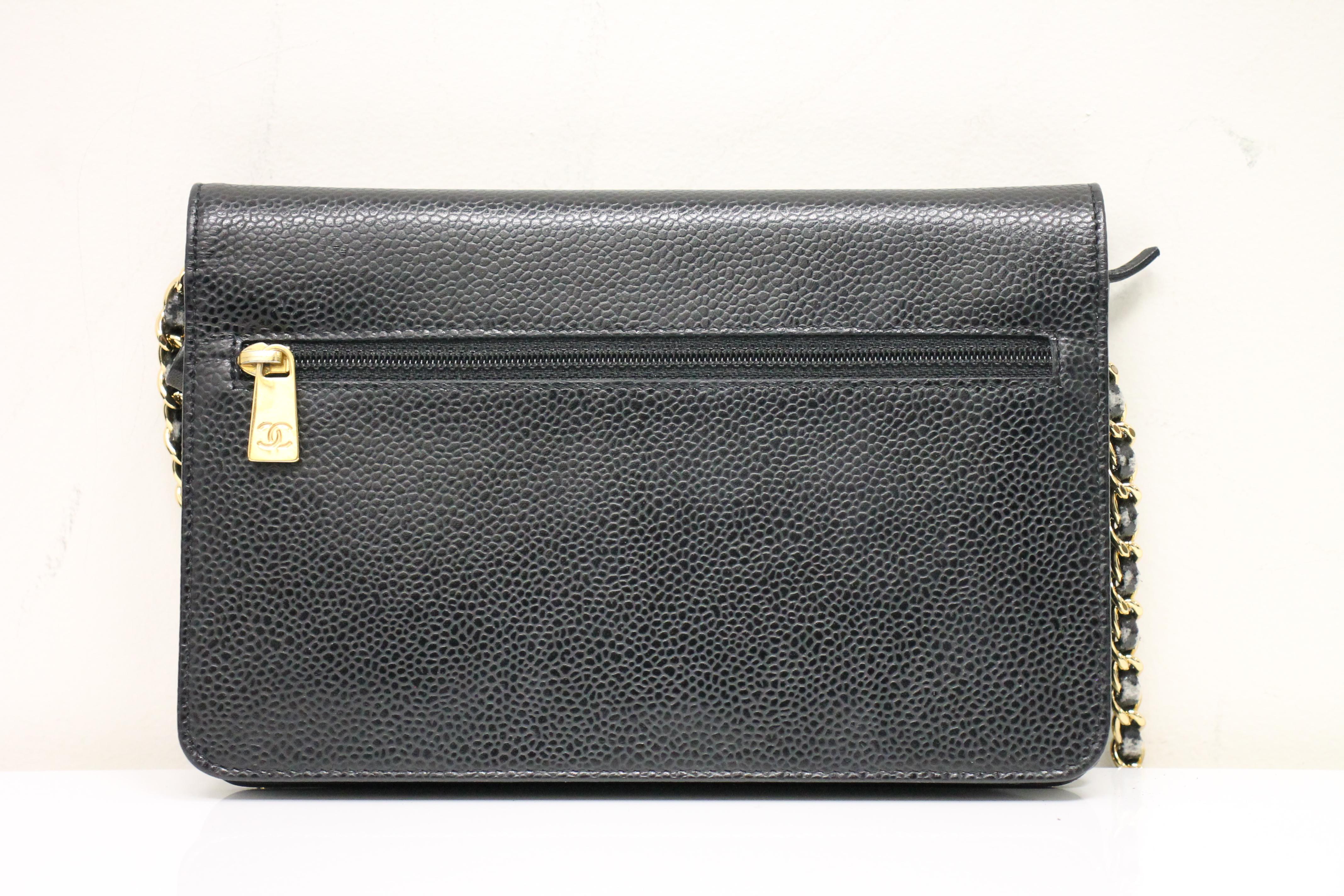 Black leather. Gold-tone hardware. Front flap with snap closure. Embroidered 