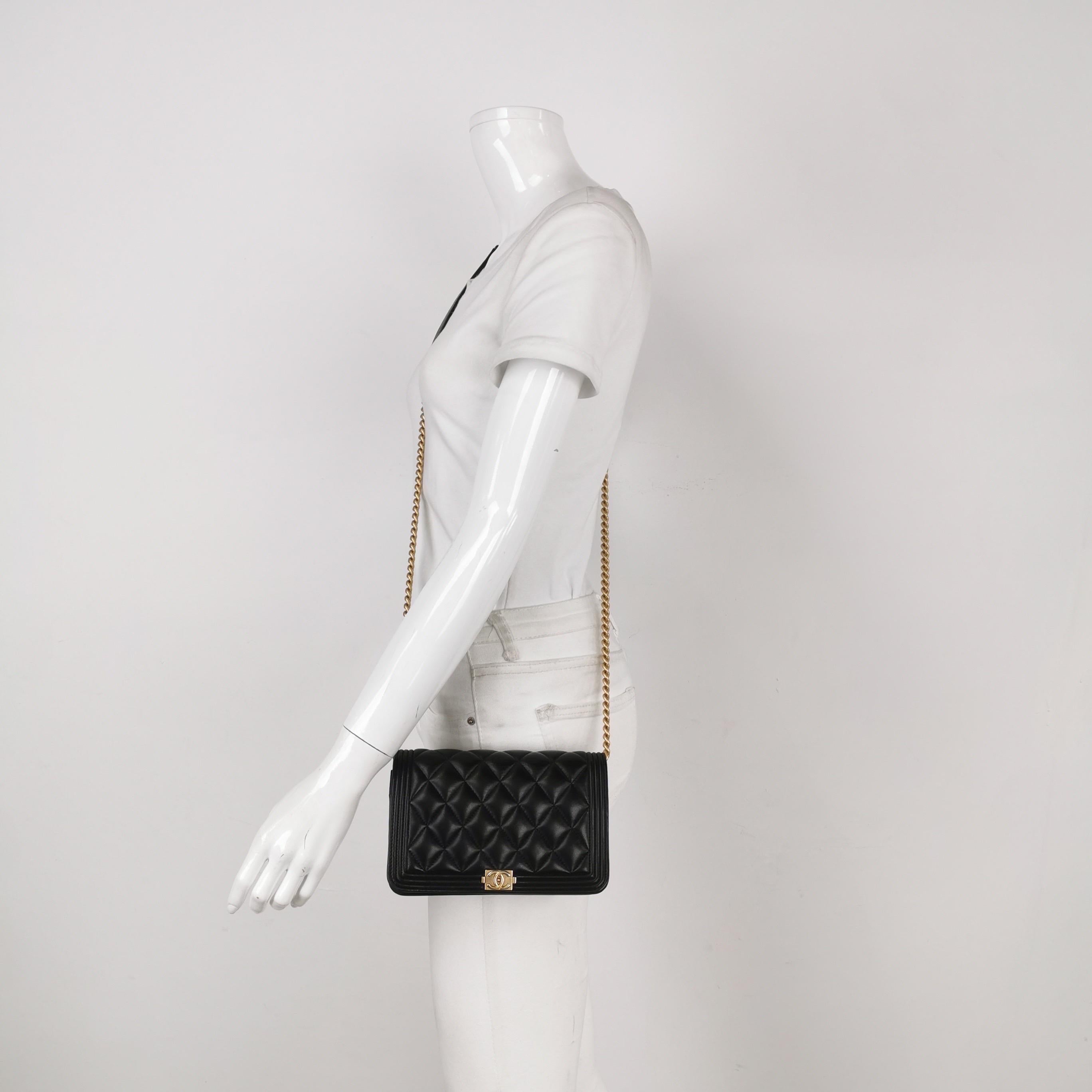 This luxurious Chanel Wallet on Chain WOC Boy is crafted with black lambskin leather and antiqued gold hardware, a perfect blend of classic style and contemporary edge. It offers a chic shoulder or cross-body wear option, with a tiny CC lock and a