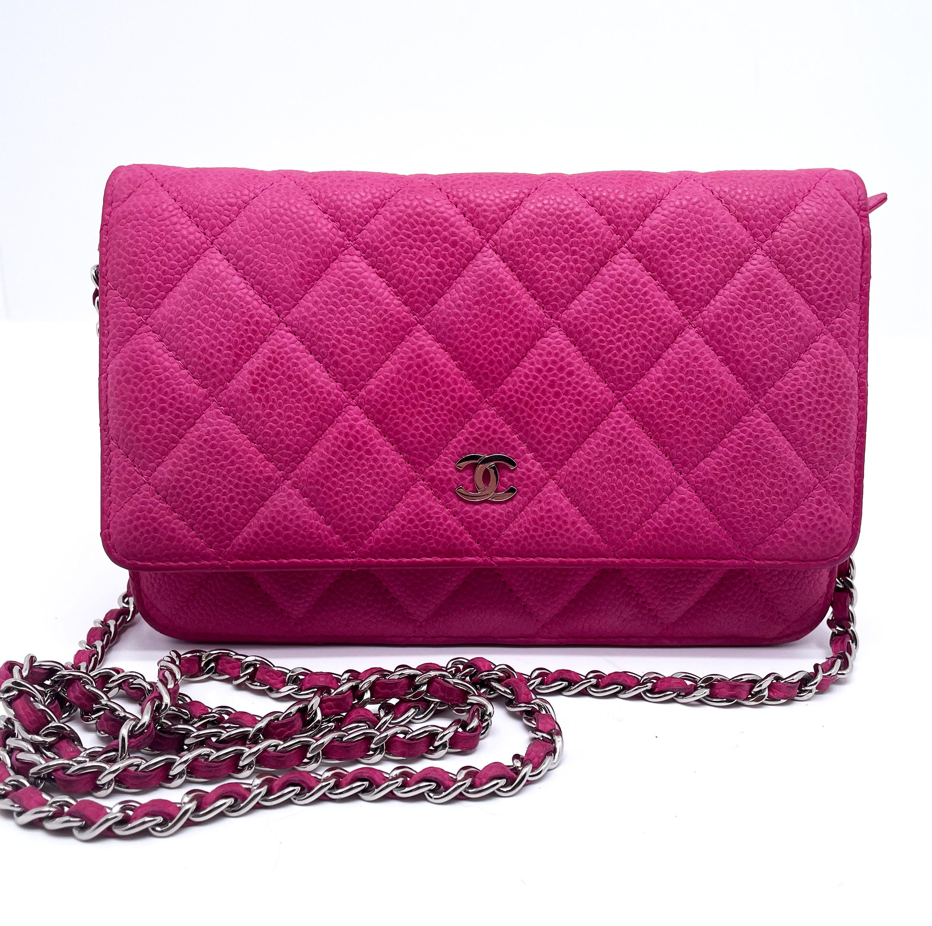 This fuschia pink Chanel Wallet on chain is made of quilted Grained Calfskin.
The caviar leather woc bag has a golden chain 150 cm long with a small
golden 'CC' logo on the flap. The inside of the bag offers space for
cards and other personal