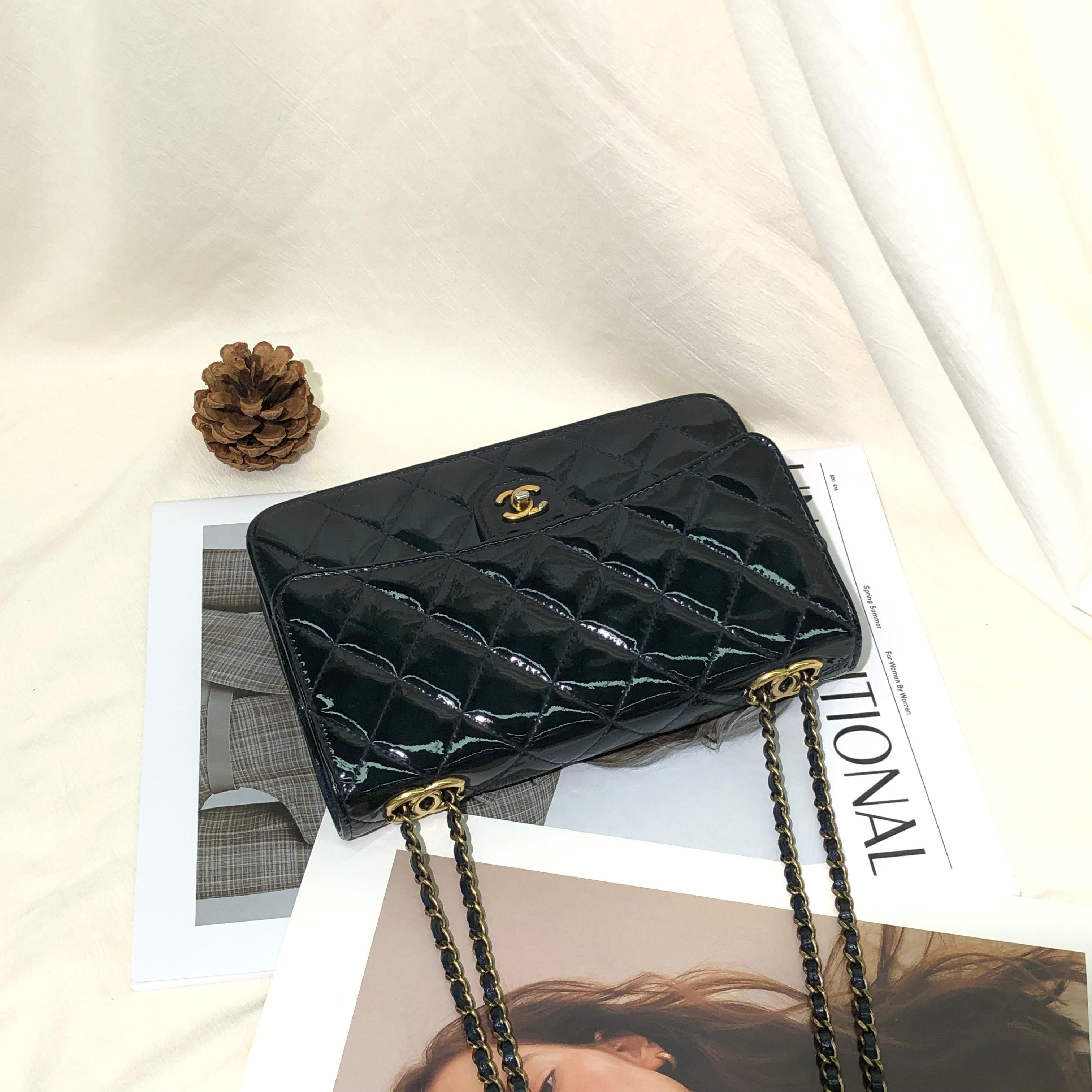 Chanel Wallet on Chain Navy Patent Leather Gold-tone Double Chain, 2015-2016
  These are professional photos of the actual bag offered by Luxbags.
  
  Perfect for any occasion, the Chanel Wallet on Chain WOC is crafted from patent leather in navy