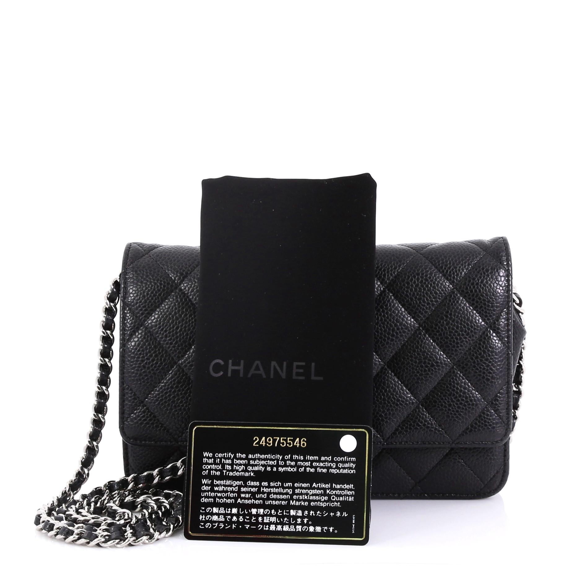 This Chanel Wallet on Chain Quilted Caviar, crafted in black quilted caviar leather, features woven-in leather chain strap, front flap with CC logo, and silver-tone hardware. Its magnetic snap button closure opens to a burgundy fabric and leather