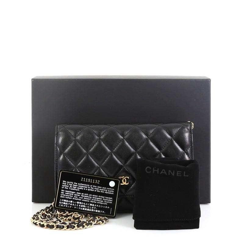 This Chanel Wallet on Chain Quilted Lambskin, crafted in black quilted lambskin leather, features woven-in leather chain strap, front flap with CC logo, exterior back slip pocket, and gold-tone hardware. Its magnetic snap button closure opens to a
