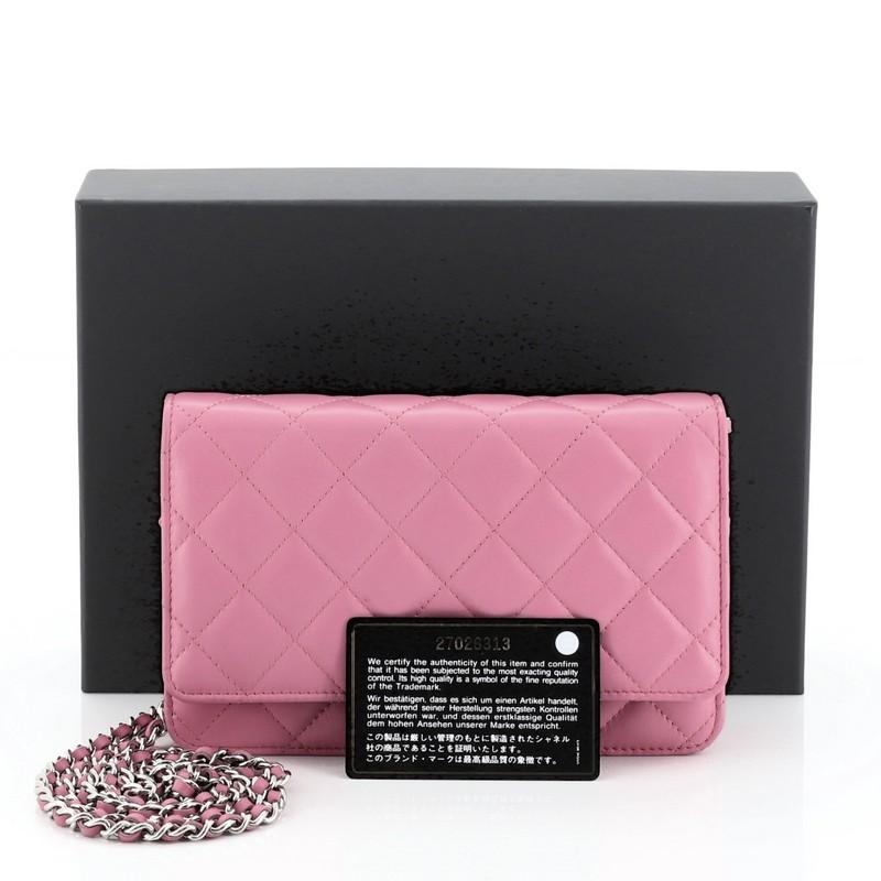 This Chanel Wallet on Chain Quilted Lambskin, crafted in pink quilted lambskin leather, features woven-in leather chain strap, front flap with CC logo, exterior back slip pocket, and silver-tone hardware. Its magnetic snap button closure opens to a