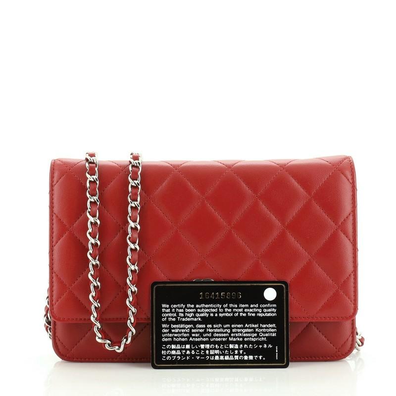 This Chanel Wallet on Chain Quilted Lambskin, crafted in red quilted lambskin leather, features woven-in leather chain strap, front flap with CC logo, exterior back slip pocket, and silver-tone hardware. Its magnetic snap button closure opens to a