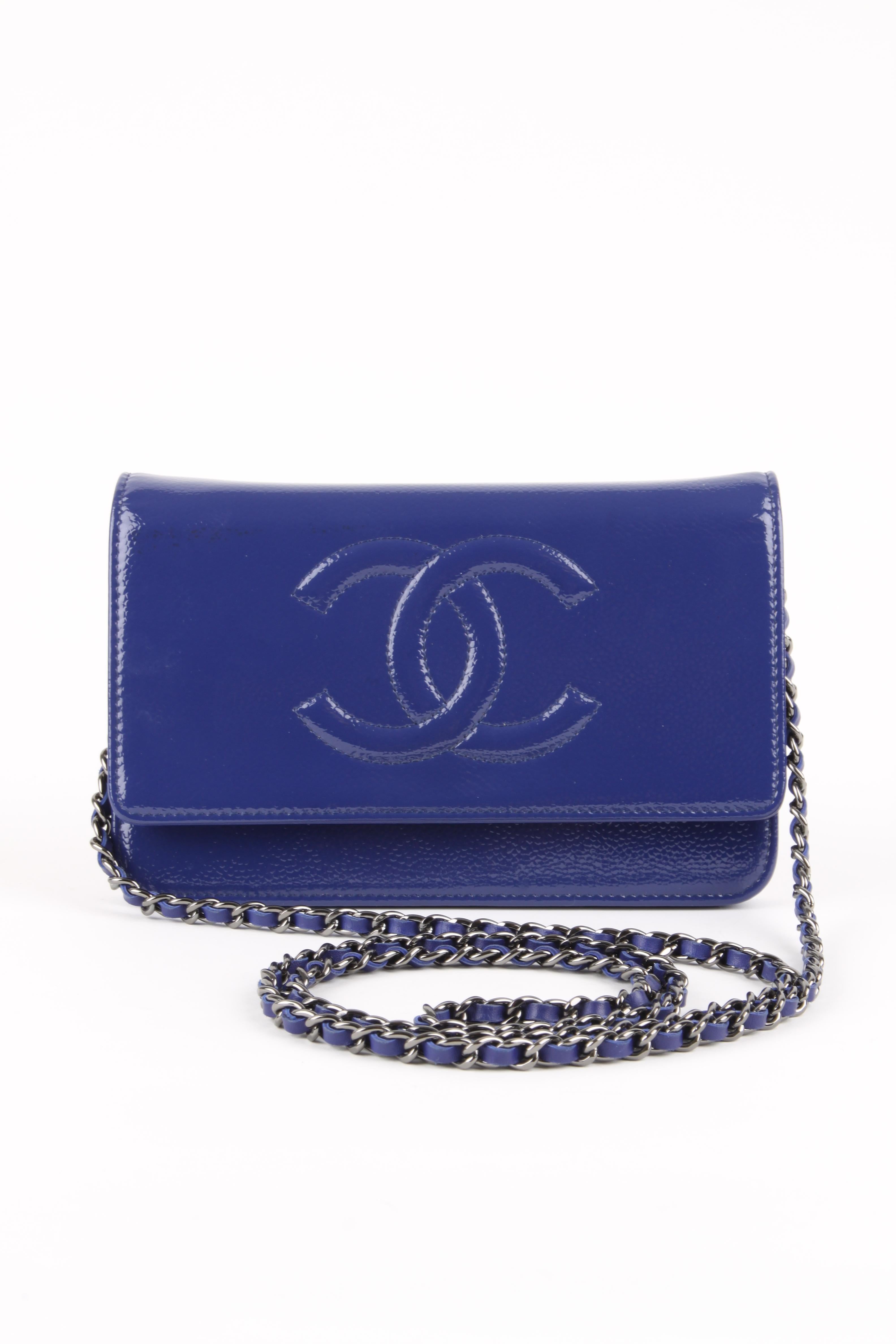 Highly desirable Chanel bag; it is the Wallet on Chain! Wearable on the shoulder and also cross body, of course.

Shiny blue patent leather and silver hardware, a large embroidered interlocking CC logo on the flap. The chain has blue leather