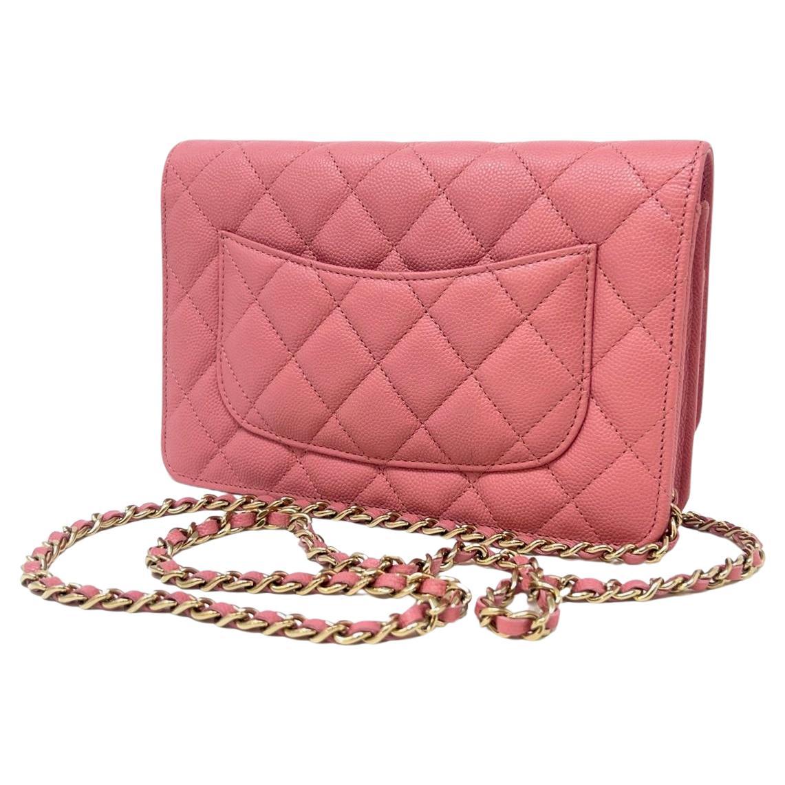 This Chanel quilted Wallet on Chain inPink is in caviar leather with Gold tone hardware, has tonal stitching, a front flap, a CC snap lock closure, a half moon back pocket, and Gold tone chain with a rose Pink leather interwoven shoulder/crossbody