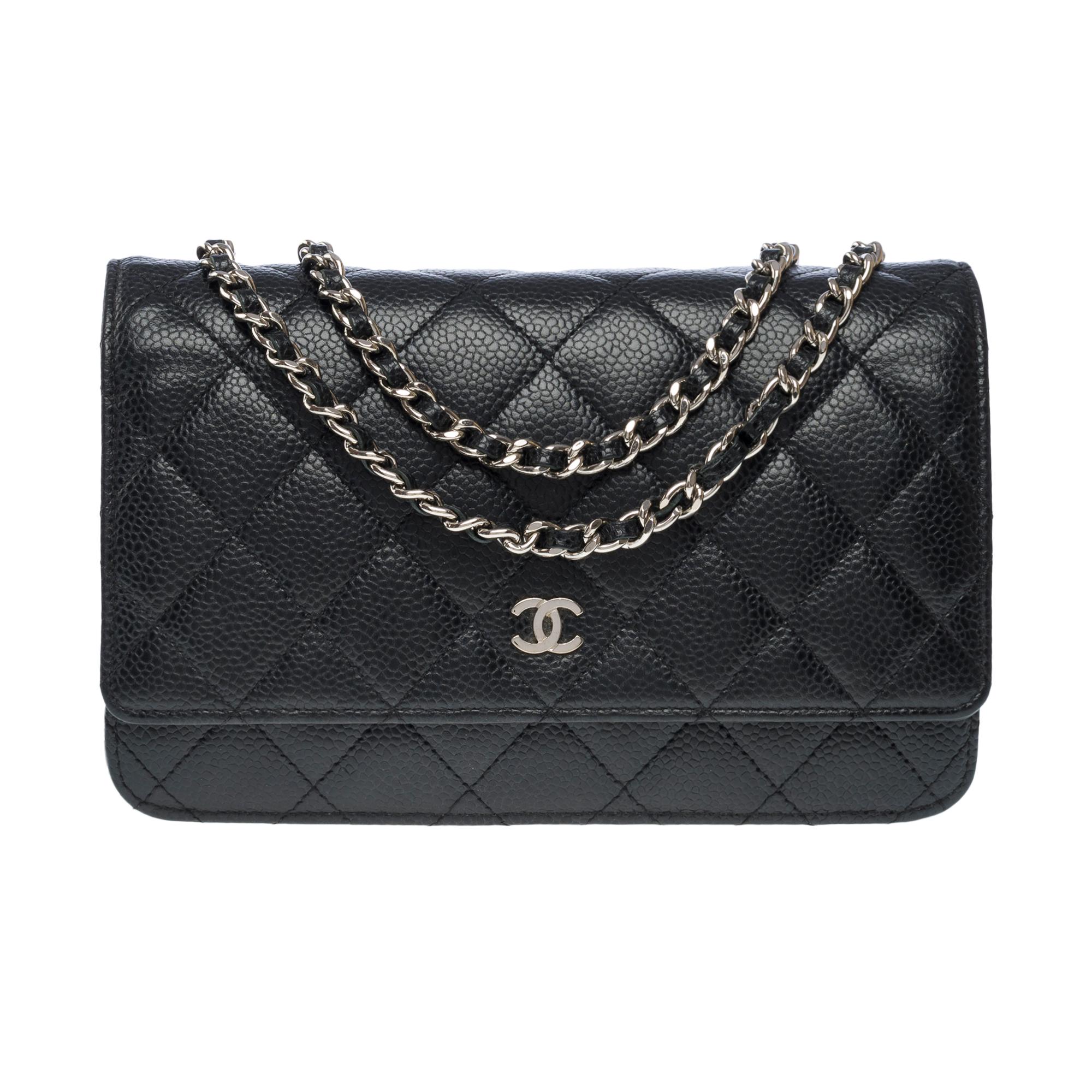 Gorgeous​​ ​​Chanel​​ ​​Wallet​​ ​​On​​ ​​Chain​​ ​​shoulder​​ ​​bag​​ ​​(WOC)​​ ​​in​​ ​​black​​ ​​quilted​​ ​​caviar​ ​leather,​​ ​​silver​​ ​​metal​​ ​​trim,​​ ​​a​​ ​​silver​​ ​​metal​​ ​​chain​​ ​​interlaced​​ ​​with​​ ​​black​​ ​​leather​​