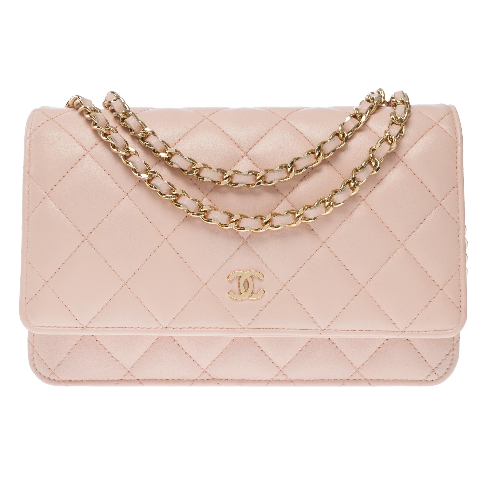 Superb​ ​Chanel​ ​Wallet​ ​On​ ​Chain​ ​(WOC)​ ​shoulder​ ​bag​ ​in​ ​pale​ ​pink​ ​quilted​ ​smooth​ ​lambskin,​ ​gold-tone​ ​metal​ ​hardware,​ ​a​ ​gold-tone​ ​metal​ ​chain​ ​strap​ ​interwoven​ ​with​ ​pink​ ​leather​ ​Allowing​ ​for​