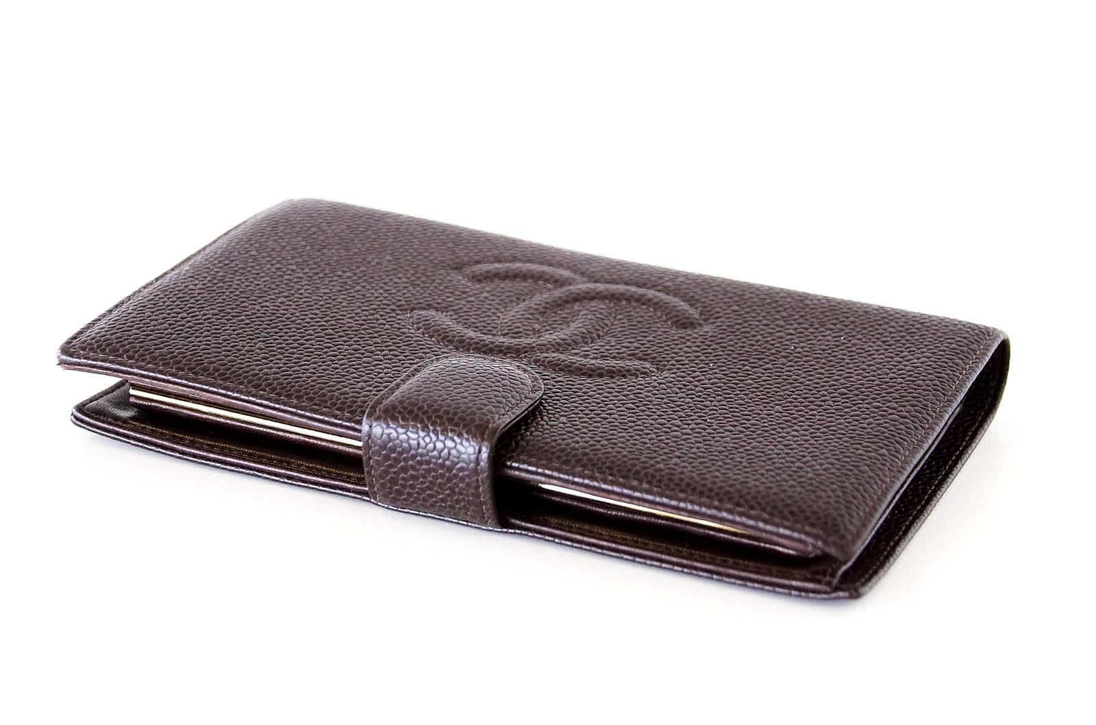 Guaranteed authentic Chanel vintage long bifold brown caviar leather wallet.
Front CC embossed logo. 
6 credit card slots.
Checkbook slot and change purse with embossed snap close.
Exterior is in mint condition; interior is gently marked from