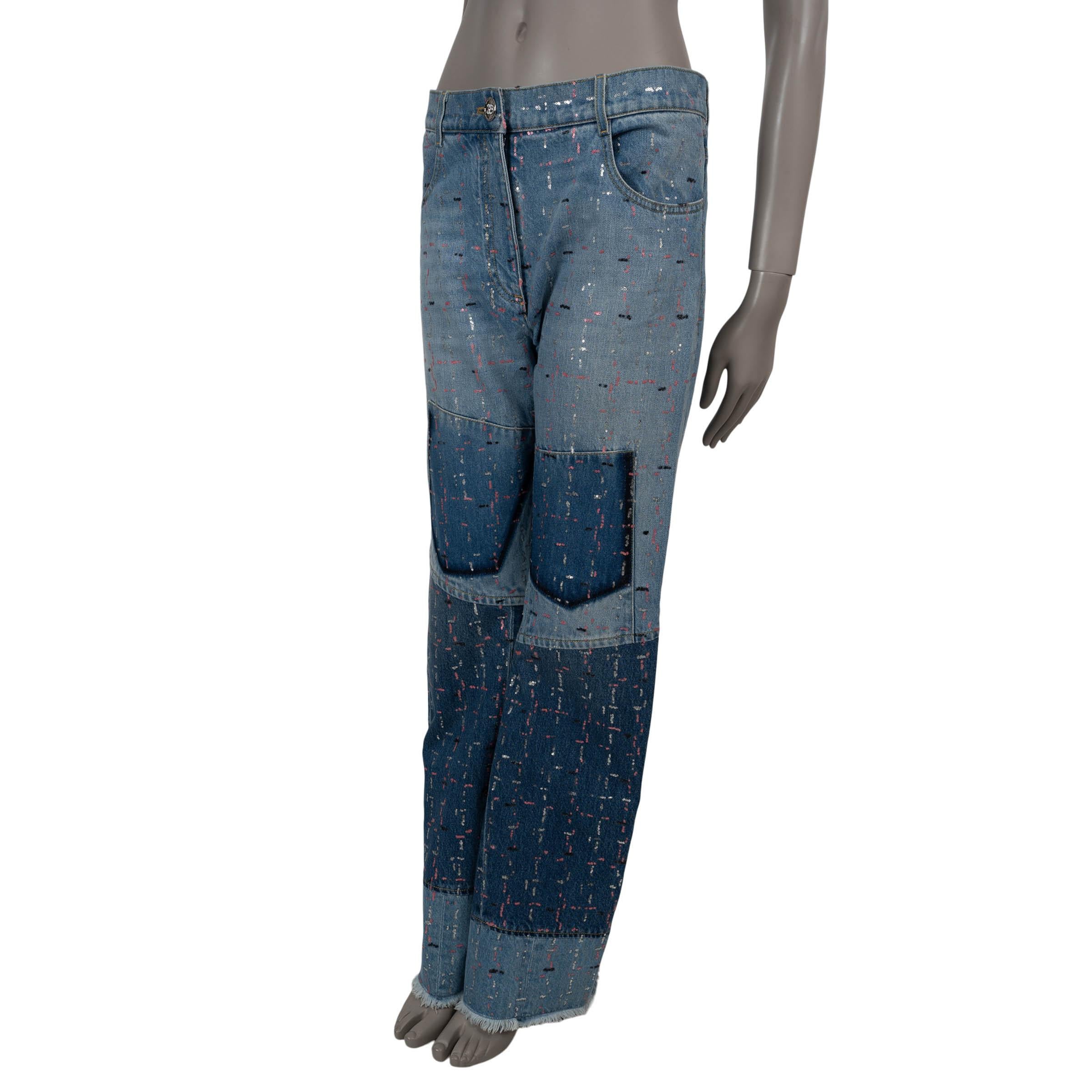 This 100% authentic Chanel patchwork jeans in various shades of washed blue denim cotton (100%) exude effortless luxury with an artistic edge. Adorned with short rows of pink, black, and white sequins, they showcase intricate craftsmanship.