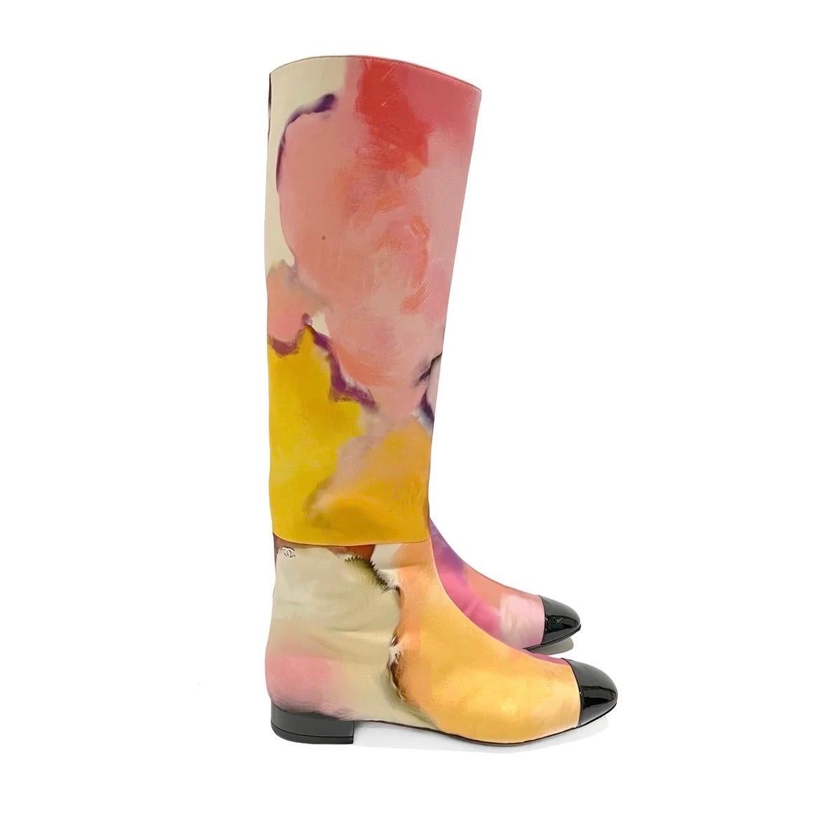 Watercolor Boots by Chanel 
Spring / Summer 2015
Made in Italy 
Pink, purple, yellow, white
Watercolor abstract print throughout
Rounded square toe
Black cap toe detail
Side zip closure
Excellent Condition; Preloved with light scuffing on the sole