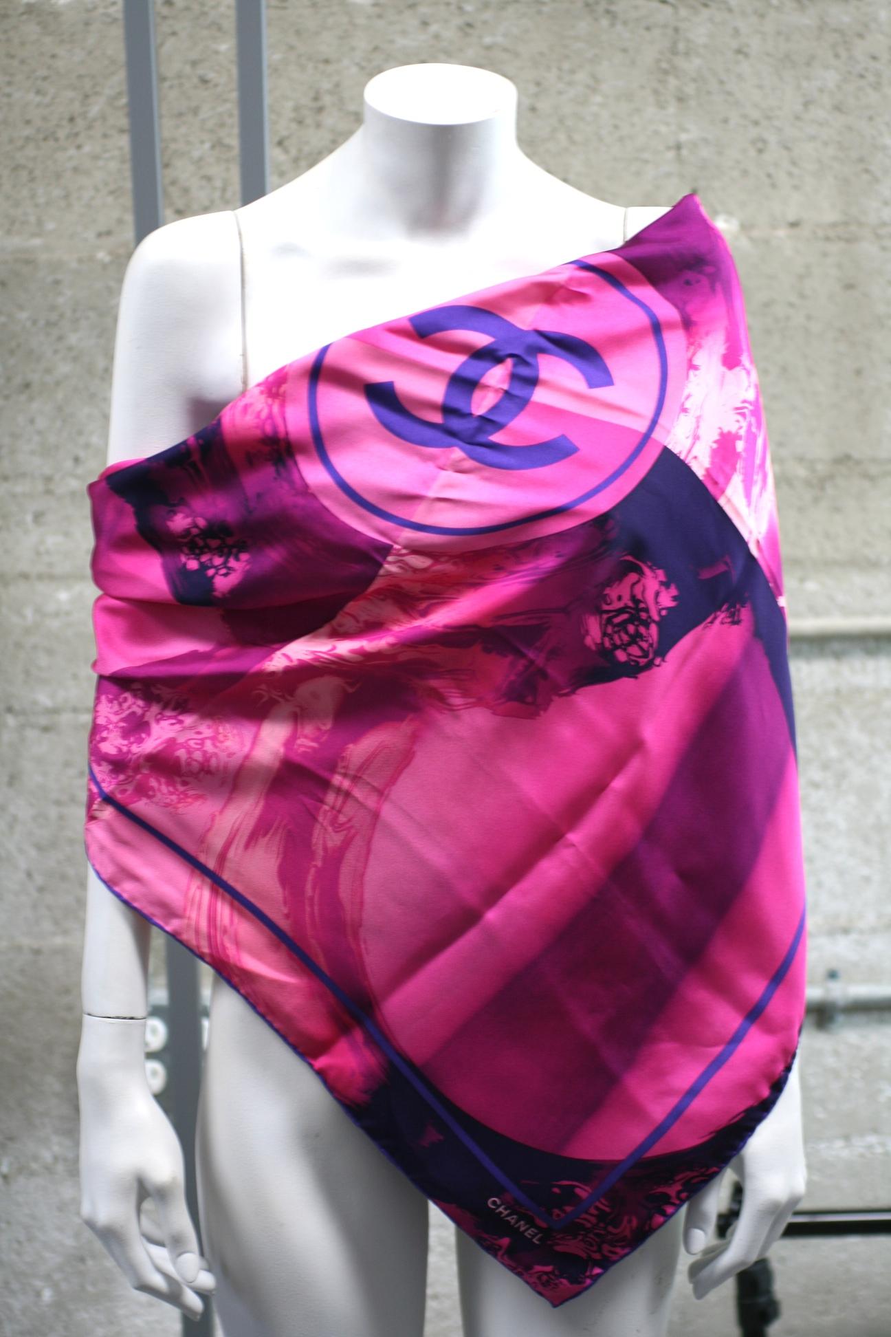 Chanel Watercolor Logo Scarf in shades of hot pinks and purples. Abstract waves swirl and splash around the central logo in silk twill. 
Excellent condition, 34