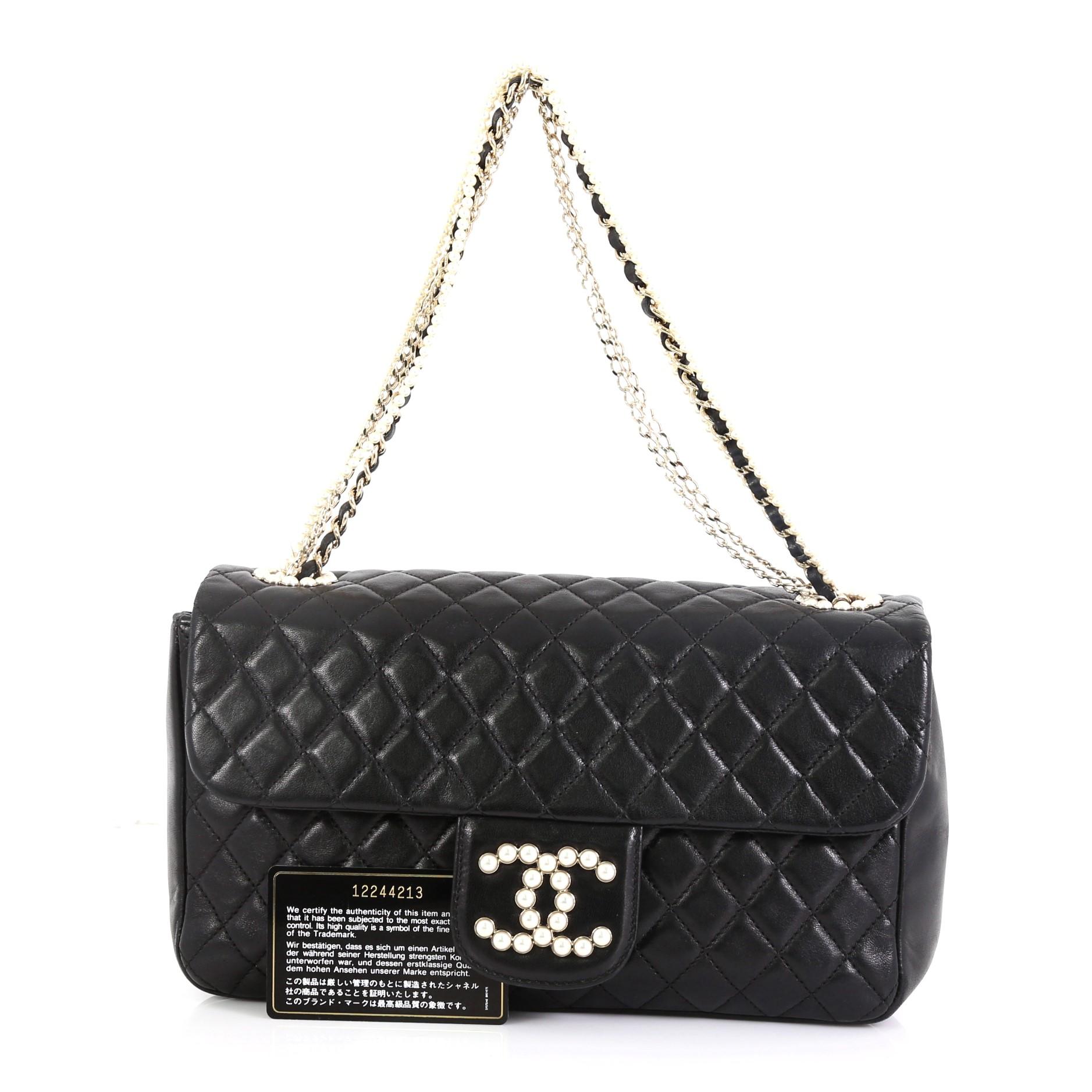 This Chanel Westminster Pearl Chain Flap Bag Quilted Lambskin Medium, crafted from black quilted lambskin leather, features chain and pearl strap, pearl-studded CC logo, and gold-tone hardware. Its magnetic snap button closure opens to a gray fabric