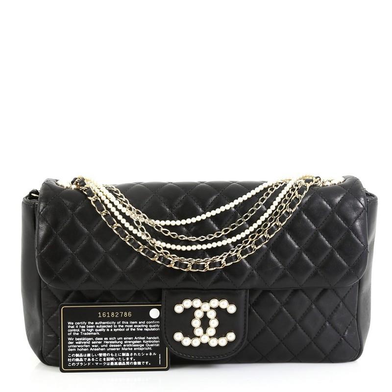 This Chanel Westminster Pearl Chain Flap Bag Quilted Lambskin Medium, crafted from black quilted lambskin leather, features chain and pearl strap, pearl-studded CC logo, and gold-tone hardware. Its magnetic snap button closure opens to a gray fabric