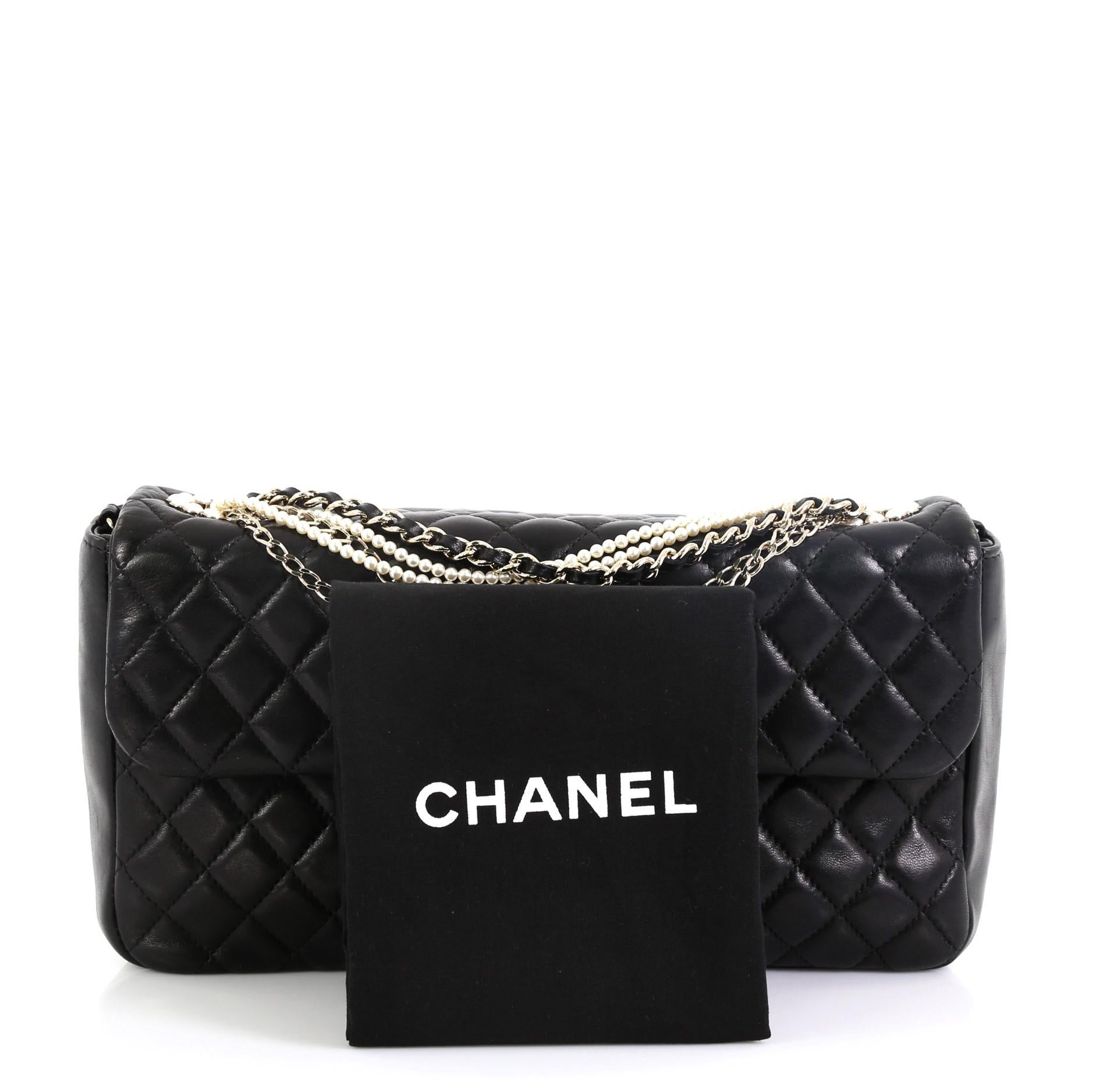 This Chanel Westminster Pearl Chain Flap Bag Quilted Lambskin Medium, crafted from black quilted lambskin leather, features chain and pearl strap, pearl-studded CC logo, and gold-tone hardware. Its magnetic snap button closure opens to a gray fabric