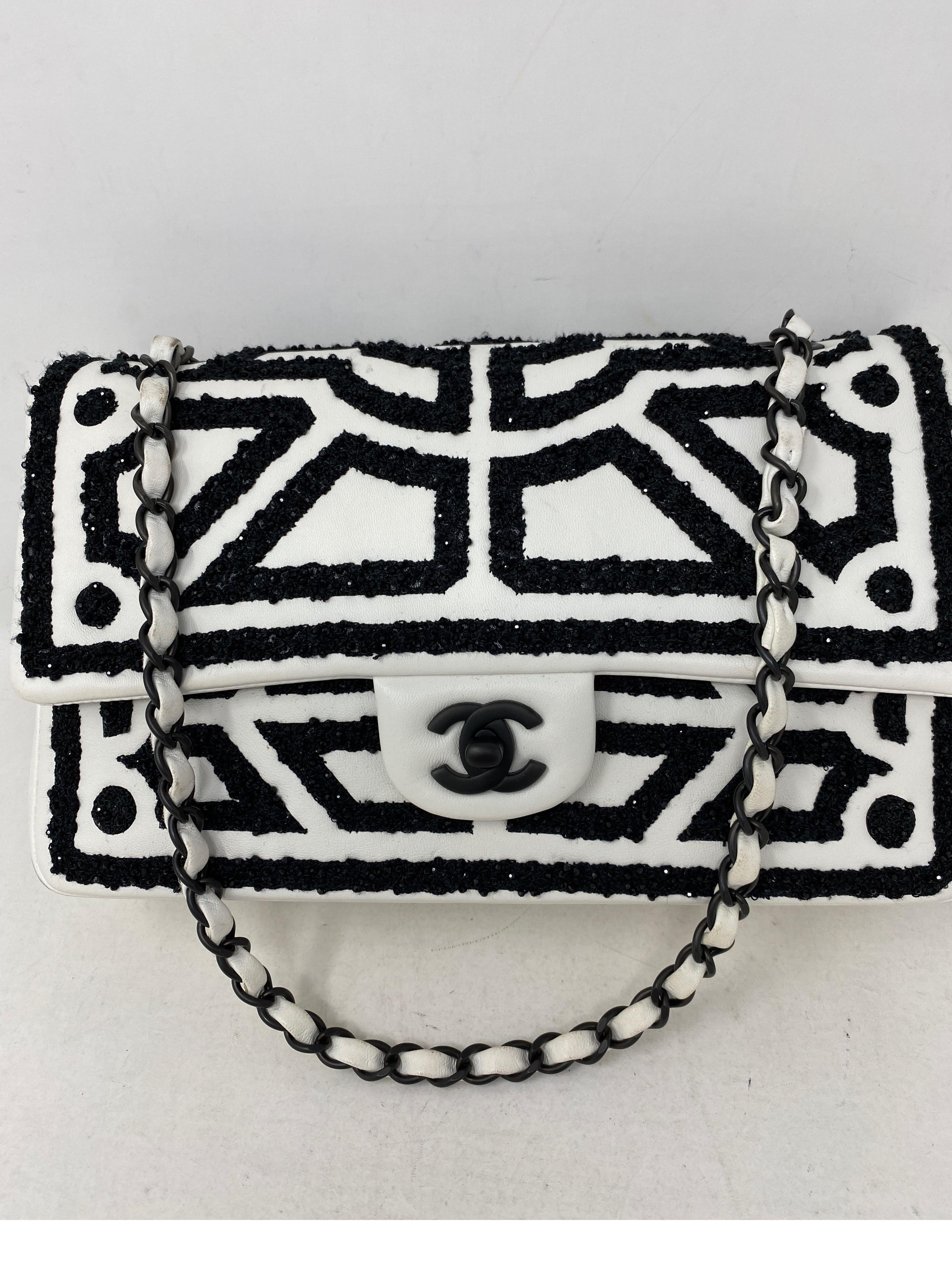 Chanel White and Black Double Flap Bag. Beautiful white leather with black eimbroidered details and pattern. Black hardware. Medium size classic. Black leather interior. Excellent condition. Rare and limited collection. Includes authenticity card.