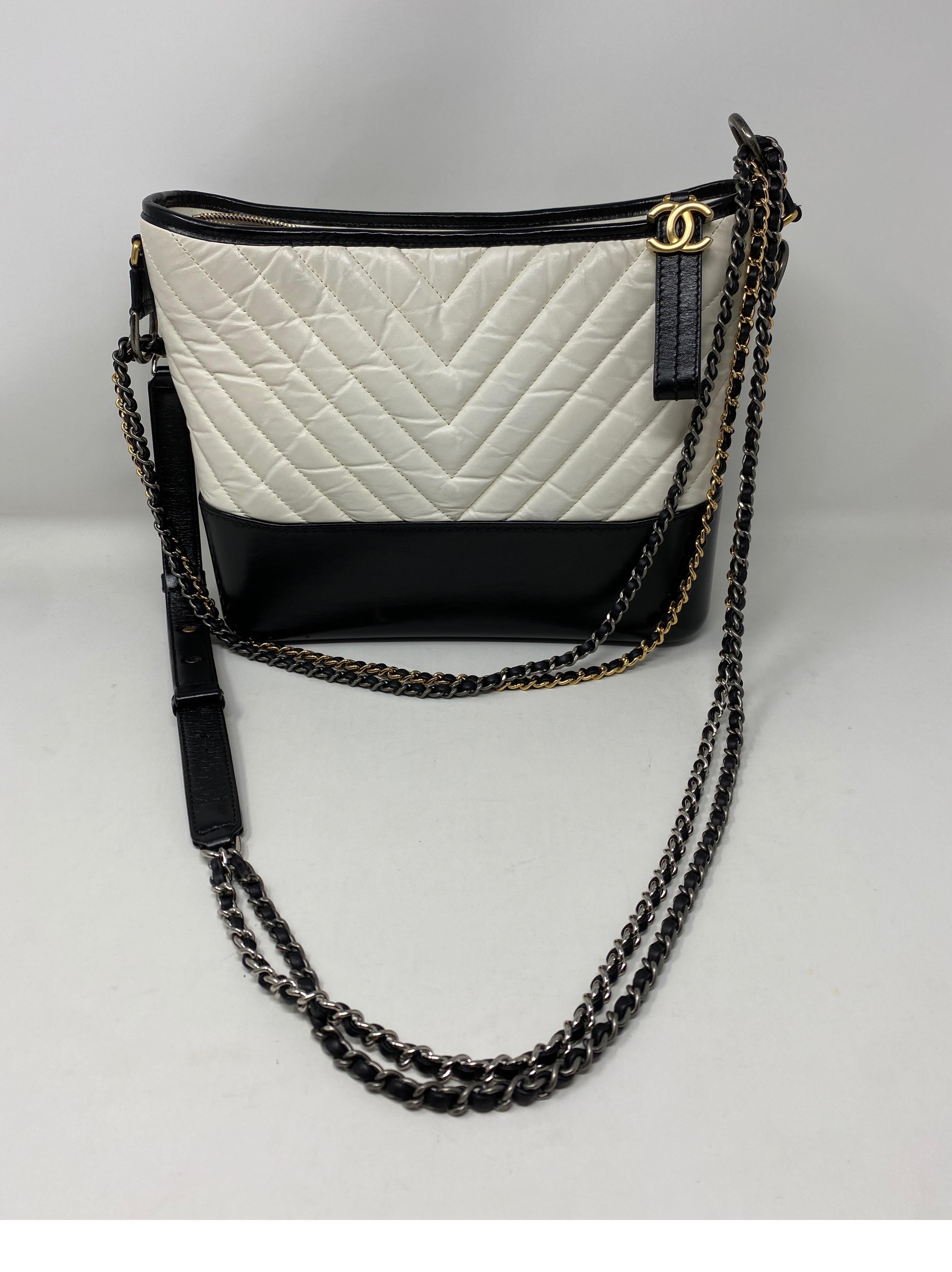 Chanel White/ Black Gabrielle Bag. Stunning two-tone bag in calf leather. Antique gold and silver hardware. Can be worn crossbody or as a shoulder bag. Can be worn multiple ways. Chevron pattern leather. Includes authenticity card and dust cover.