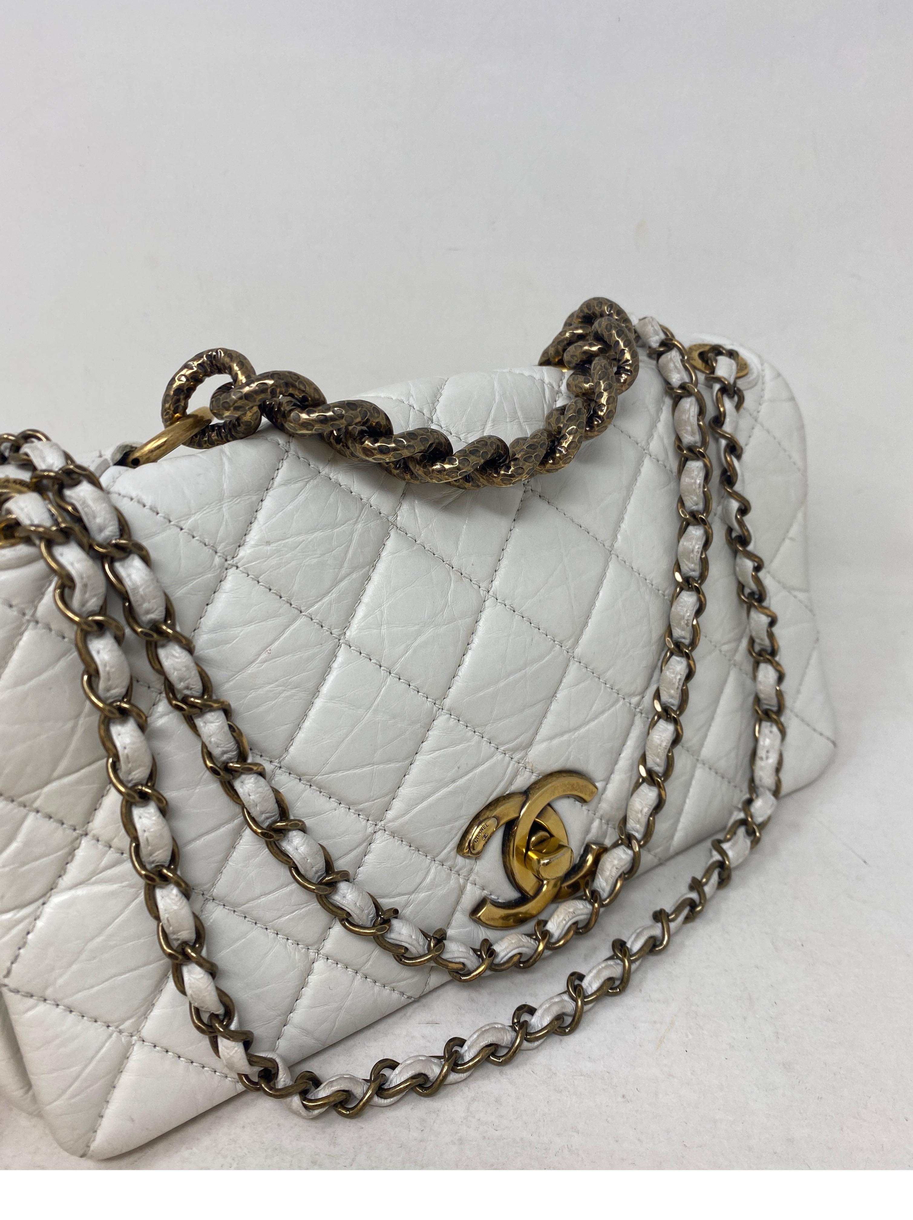 Chanel White Bag. Antique gold hardware. Winter white leather bag. Excellent condition. Can be worn as a shoulder bag or longer. Interior clean. Looks like new. Unique style bag from Chanel. Serial number is intact inside bag. Guaranteed authentic. 