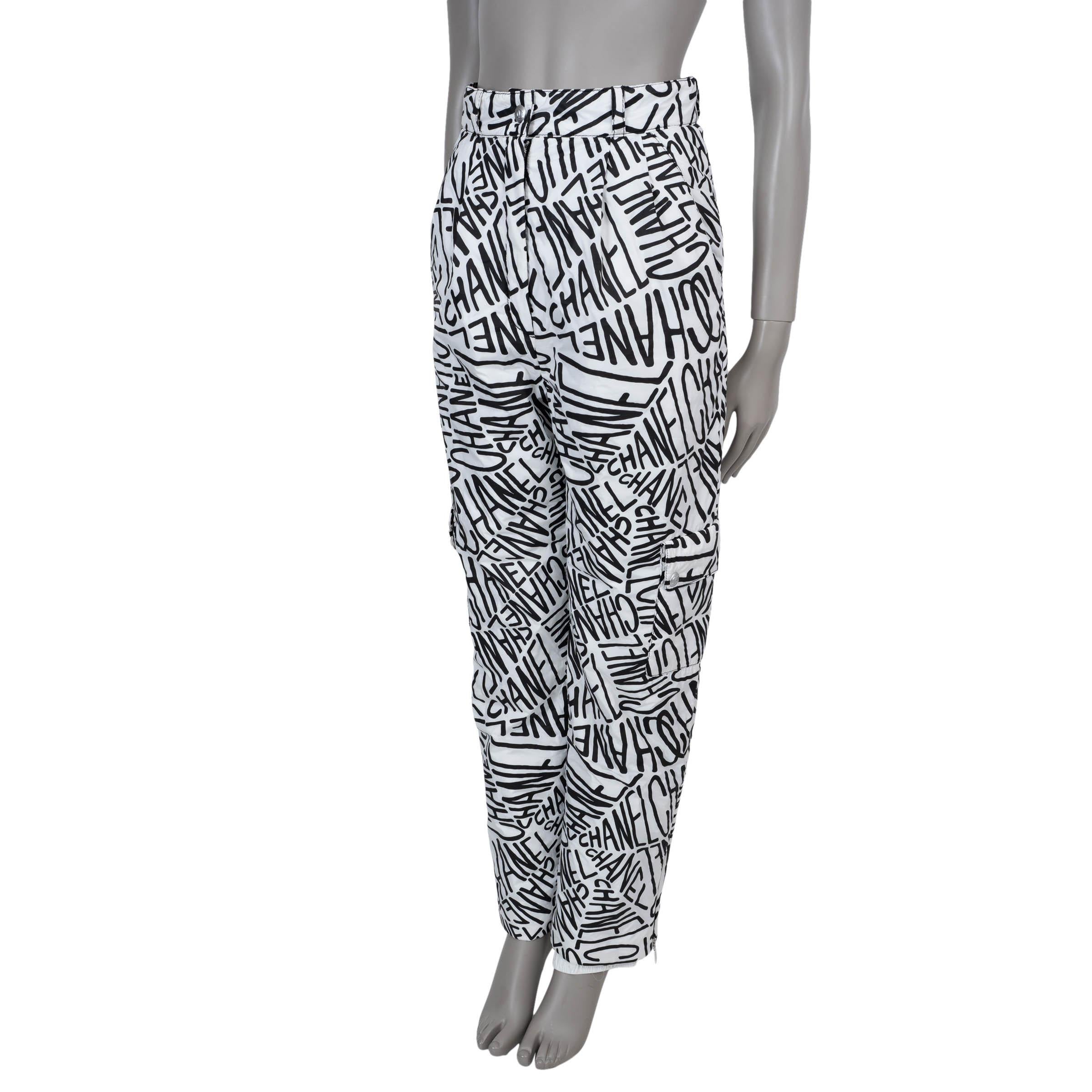 This 100% authentic Chanel ski pants in white polyester (100%) combine performance with signature style. Featuring bold black logo writing, they are designed with a tapered leg and snow catcher cuffs for optimal fit and protection. Two slant pockets