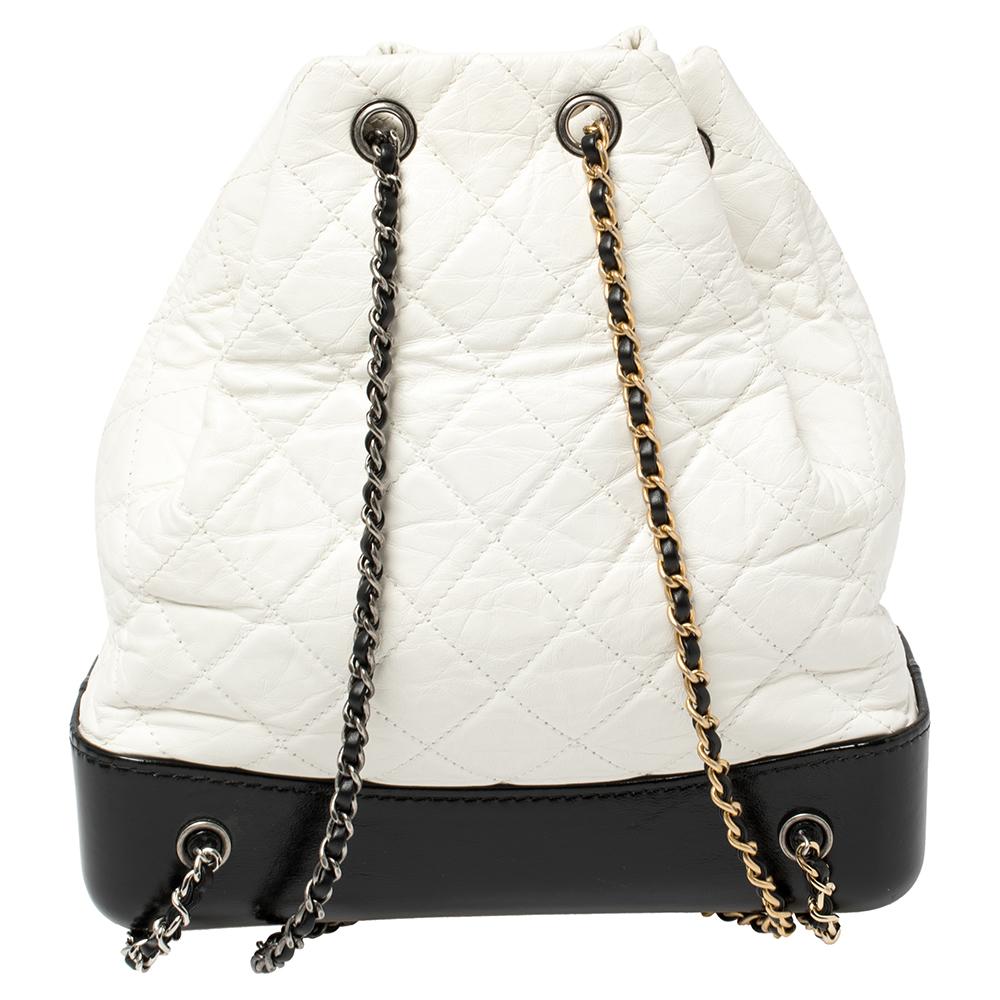 A stunning and elegant piece, this Gabrielle backpack is a timeless addition to your luxury collection. The supple body composed of quilted white leather is contrasted by a black leather base. The silver-tone hardware decorates the front's