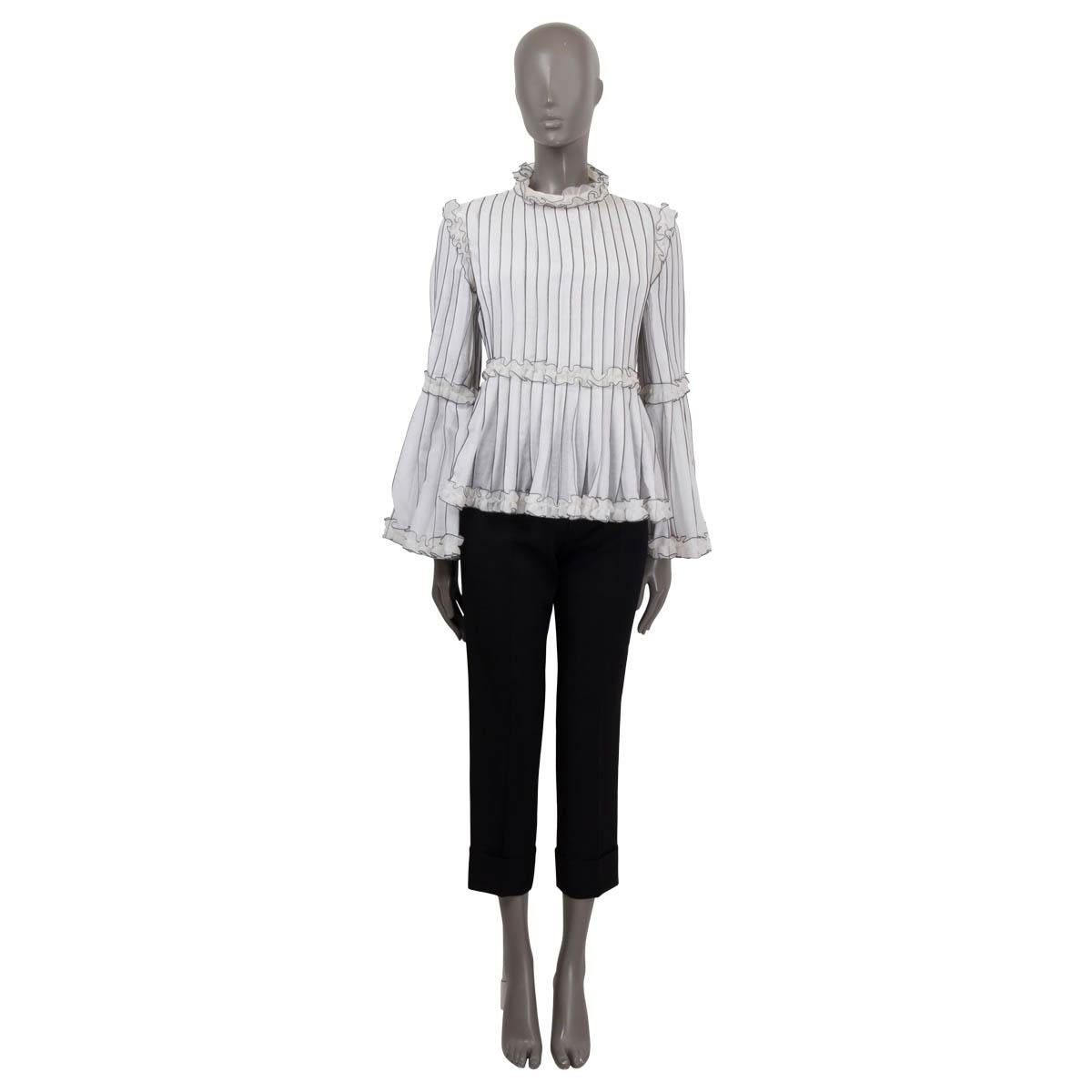 100% authentic Chanel striped blouse in white cotton blend (100%) (missing tag). Features a flared silhoutte and ruffles on the neck and flared sleeves. Closes with a velcro fasteners on the back. Unlined. Has been worn and is in excellent