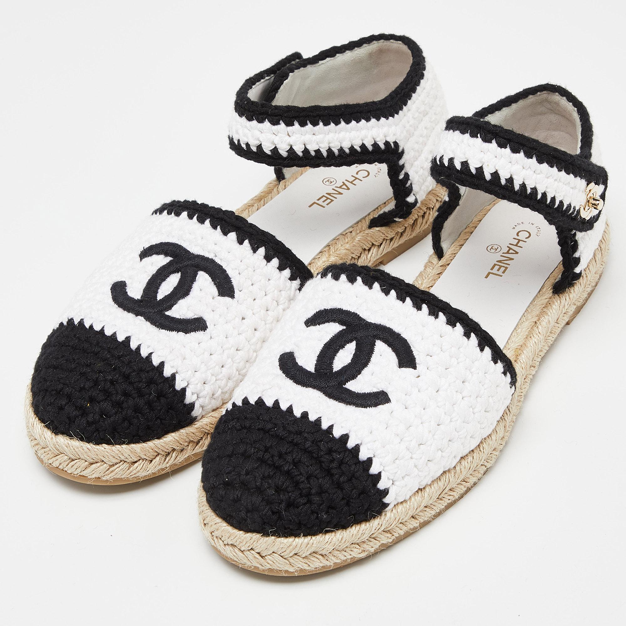 Crafted with meticulous attention to detail, these Chanel ankle strap espadrilles redefine casual chic. The intricate crochet pattern in white and black cotton blend exudes effortless style. Featuring a comfortable ankle strap and classic espadrille