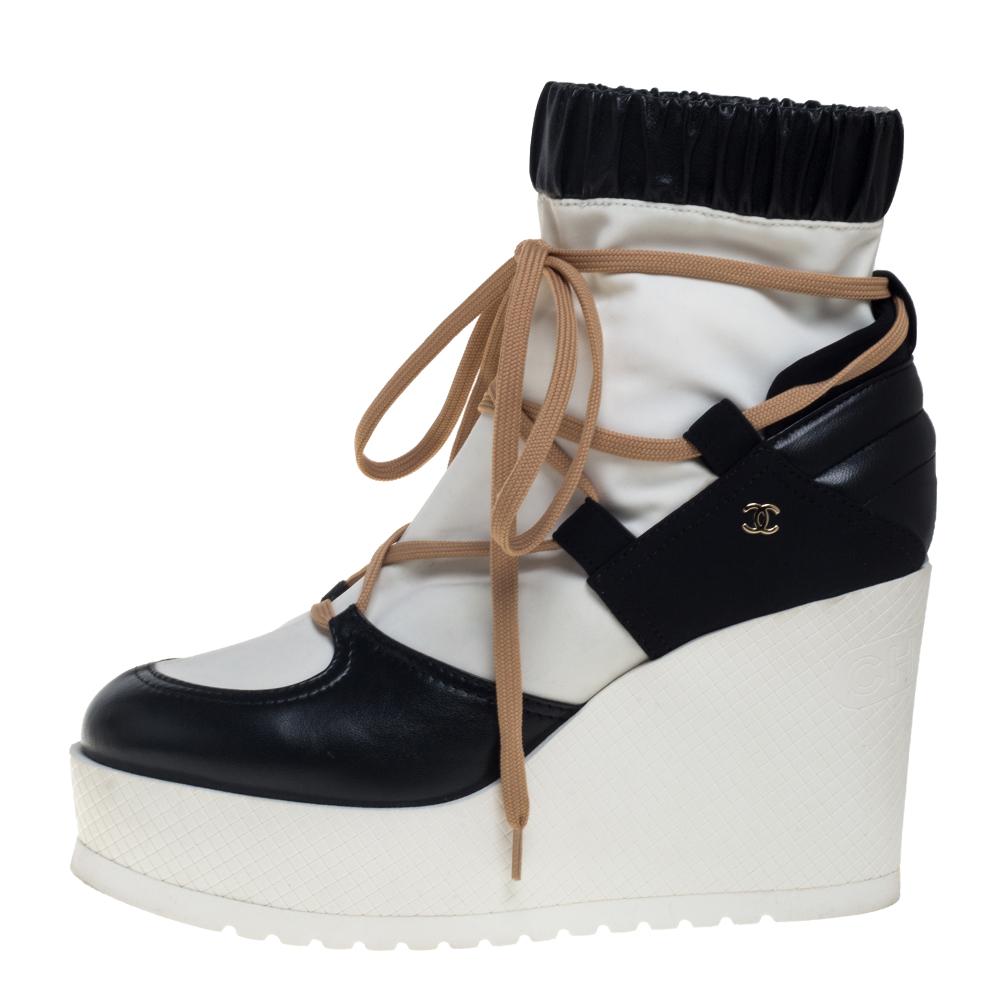 How stylish, modern, and chic do these boots from Chanel look! They are crafted from leather and blended fabric and feature round toes, lace-ups on the vamps, comfortable insoles, and 10 cm platform wedge heels. Pair them with smart denims and a