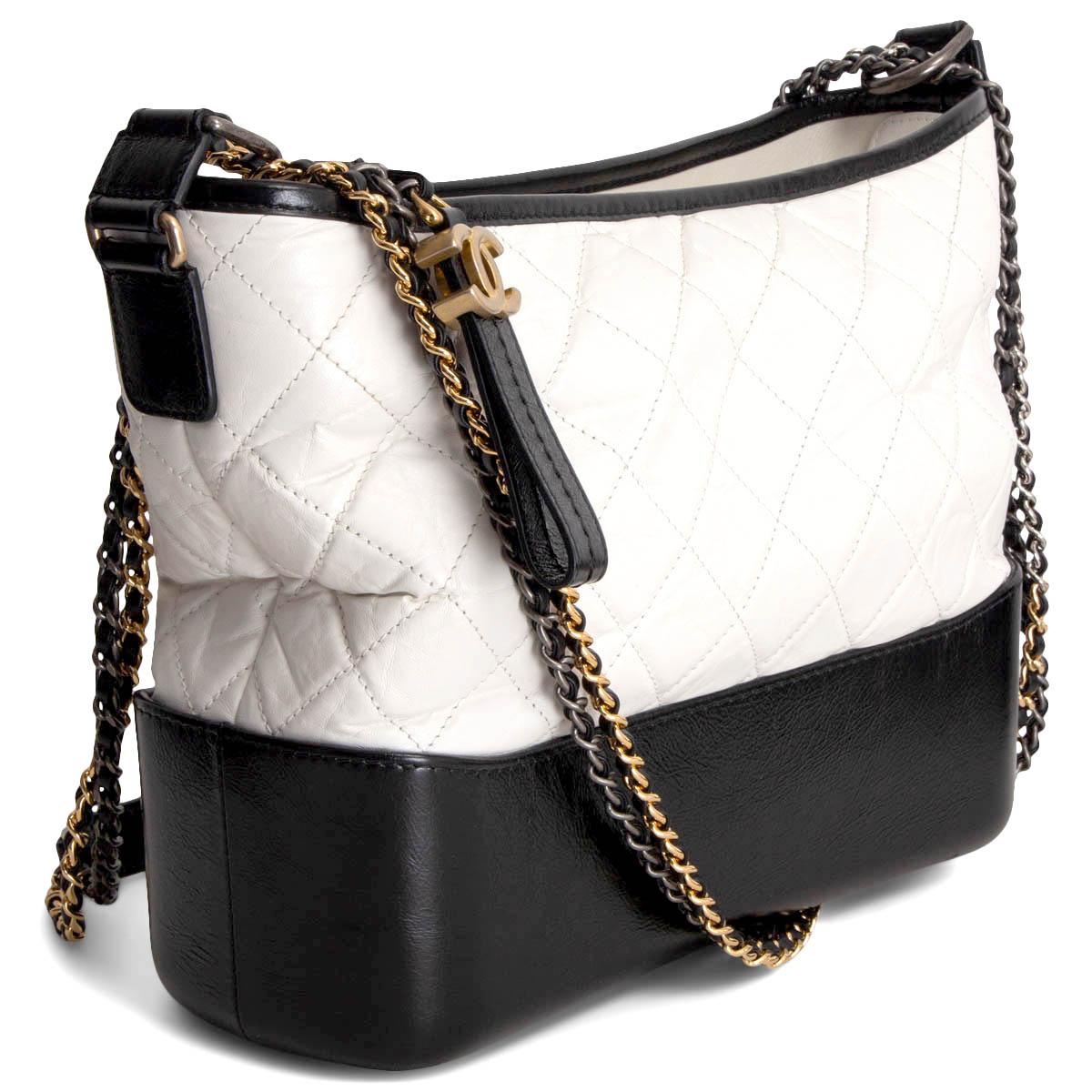 100% authentic Chanel 'Gabrielle Medium' Hobo bag in white aged calfskin and black smooth calfskin. From the 2017 fall/winter runway. Double chain shoulder-strap in gold-tone, silver-tone & ruthenium-finish metal. Opens with a CC zipper on top and