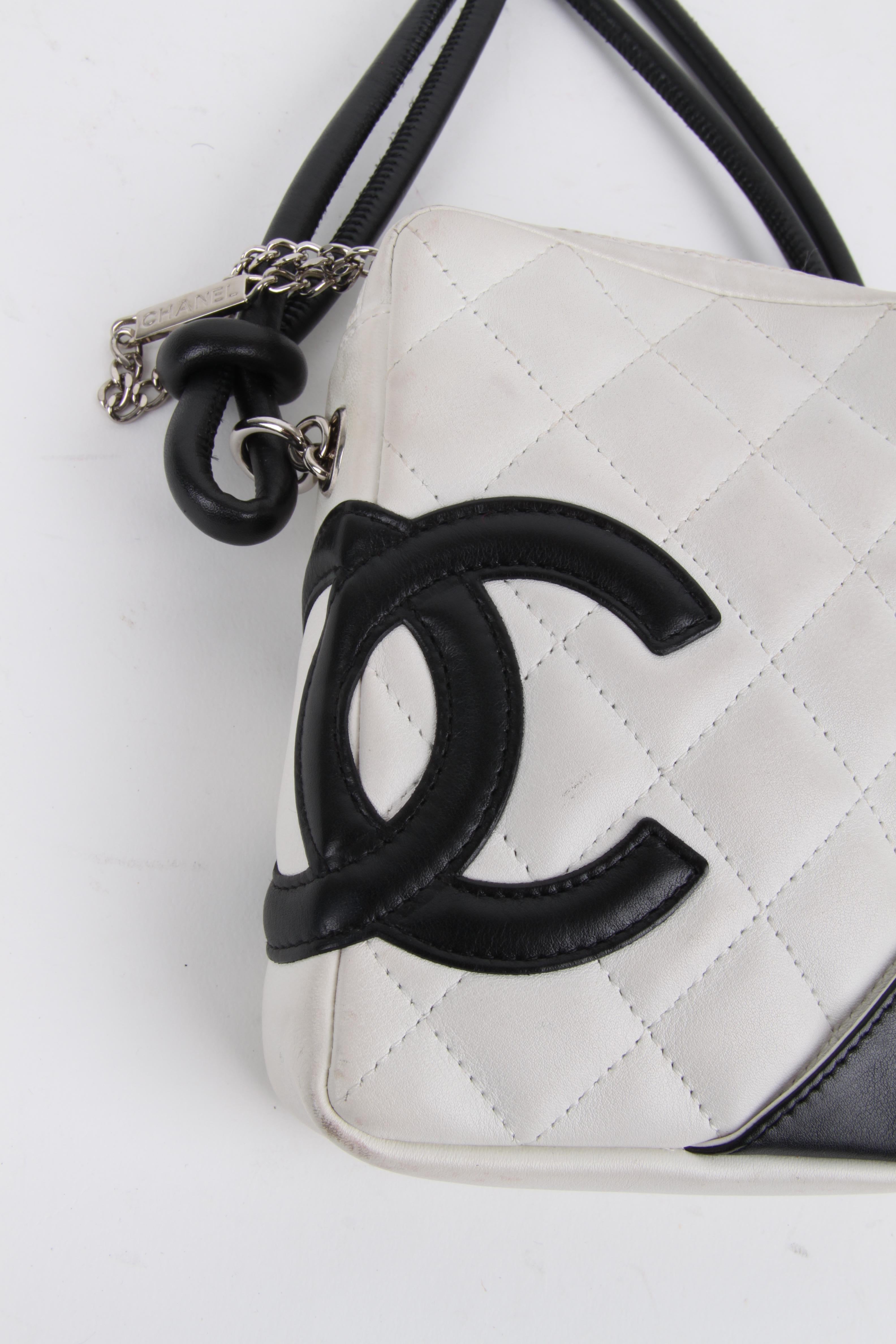 Easy to wear and casually stylish, this gorgeous Chanel Cambon crossbody bag is an elegant creation. Crafted in white quilted leather with the CC symbol in black at the front, it opens to a fabric interior where you can keep your phone, lipstick,