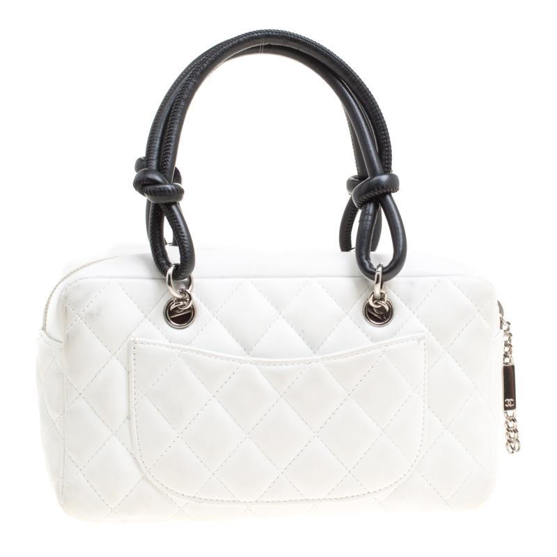 This Cambon Ligne bowler bag is just as grand as the other Chanel handbags. Exquisitely crafted from leather in a monochrome hue, it bears a functional design and their signature CC stitched on the exterior along with a slip pocket on the rear. The