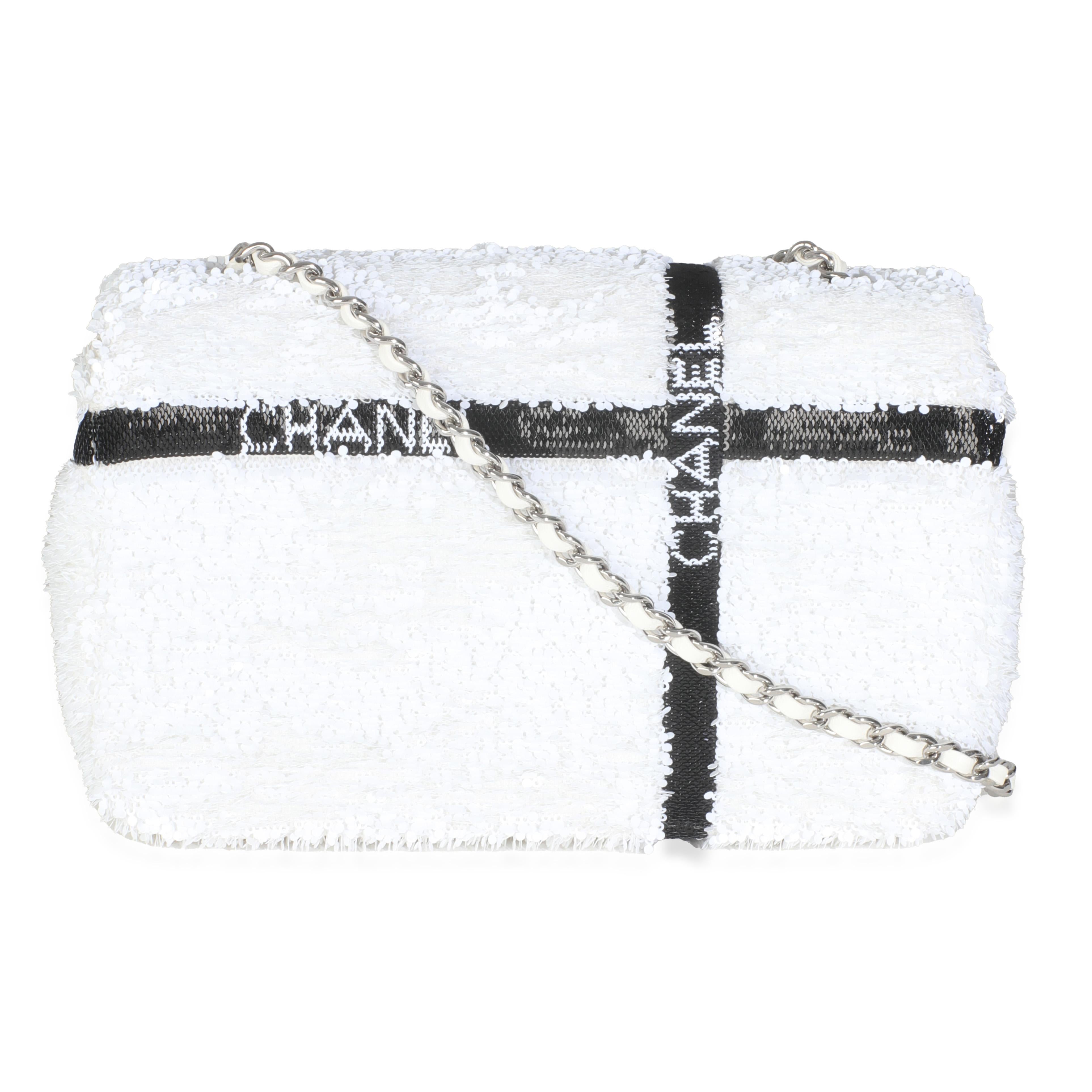 Listing Title: Chanel White Black Sequin Bow Mini Rectangular Flap Bag
SKU: Z145449
Condition: Pre-owned 
Condition Description: A timeless classic that never goes out of style, the flap bag from Chanel dates back to 1955 and has seen a number of