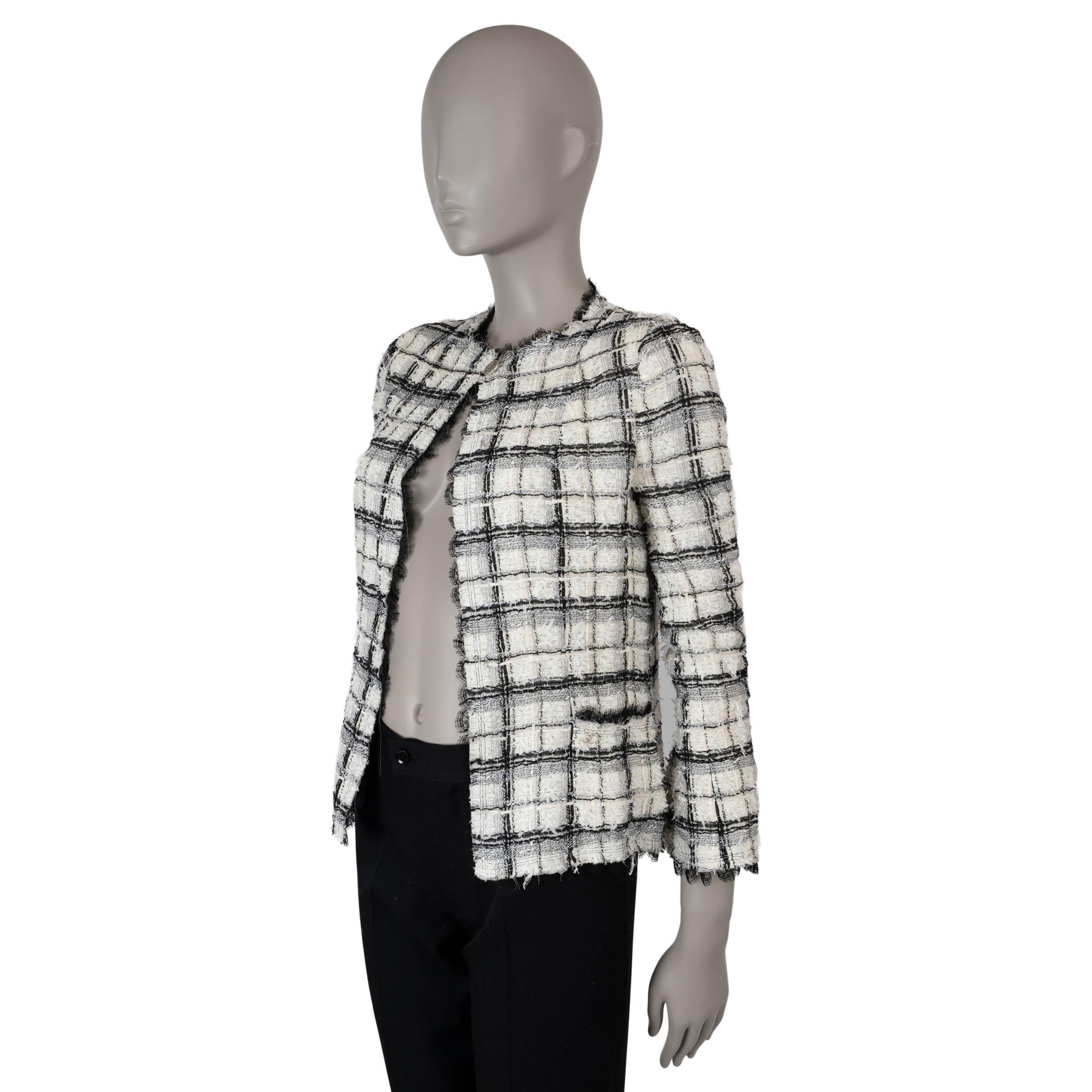 This 100% authentic Chanel plaid tweed jacket is crafted from a luxurious blend of white and black nylon (35%), silk (32%), viscose (18%), cotton (12%), acrylic (2%), and polyester (1%). It features a collarless silhouette with elegant black lace