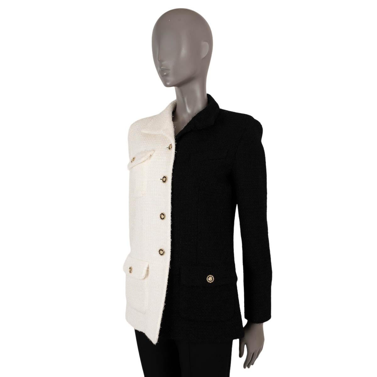 100% authentic Chanel bi-color tweed jacket in white and black wool (62%) and polyamide (38%). This iconic jacket features three buttoned flap pockets and an asymmetric collar. Closes with gold-tone lion head buttons and is lined in silk (100%). Has