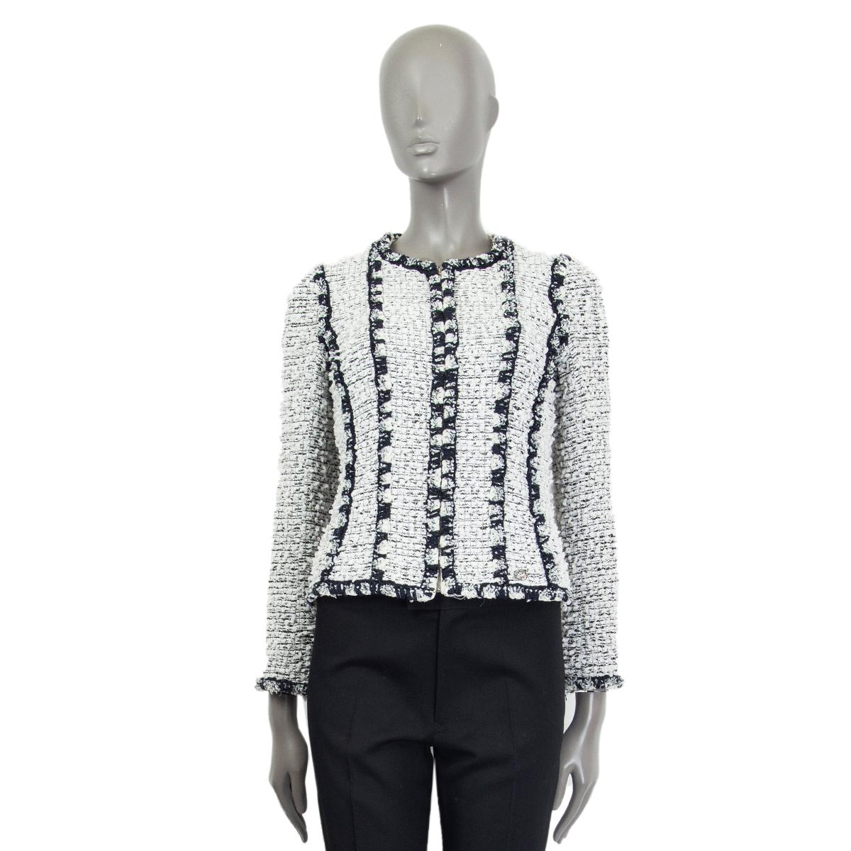 Chanel zipper bouclé jacket in white, navy and black polyamide (58%), cotton (31%) and wool (11%). Lined in white silk (100%) with a silver-tone metal chain around the bottom. Has been worn and is in excellent condition. 

Tag Size 38
Size