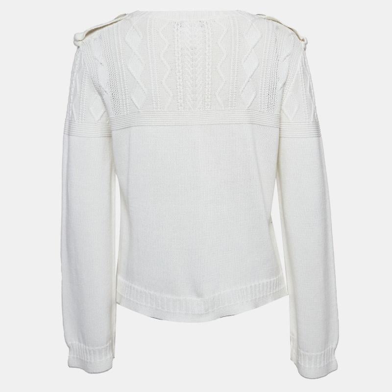 Experience timeless refinement with the Chanel sweater. Crafted with meticulous attention to detail, this luxurious garment boasts a classic cable knit design, exuding understated sophistication. Its cozy crew neck and pristine white hue make it a