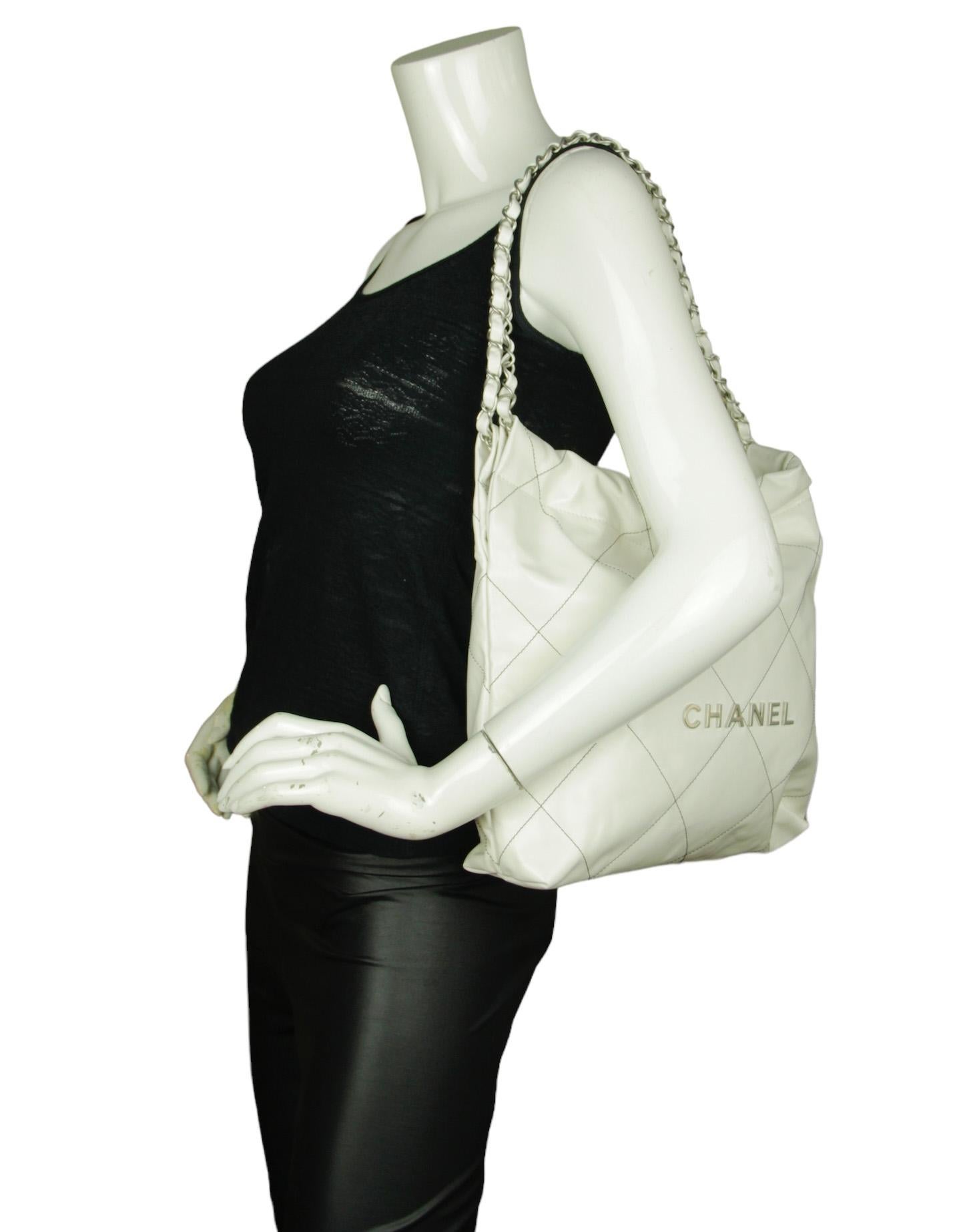 Chanel White Leather Quilted Chanel 22 Tote Bag. Features silvertone hardware spelling out CHANEL and black contrast stitching

Made In: Italy

Year of production: 2023
Color: White with black stitching
Hardware: Silvertone
Materials: Leather,