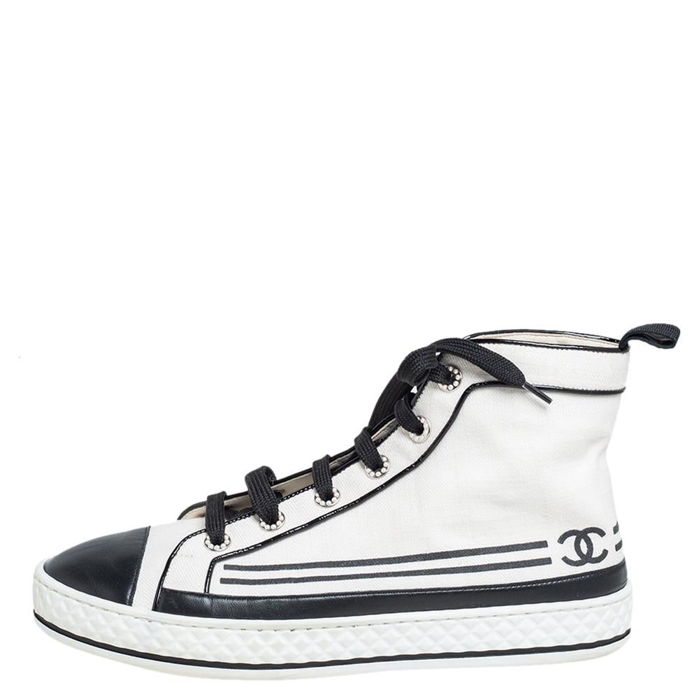Crafted from supreme quality canvas and leather, this pair of cap-toe high-top Chanel sneakers is a wardrobe staple. The sneakers will tie any outfit together. They are pearl-embellished, classy, and durable — the perfect pair to flaunt, stay