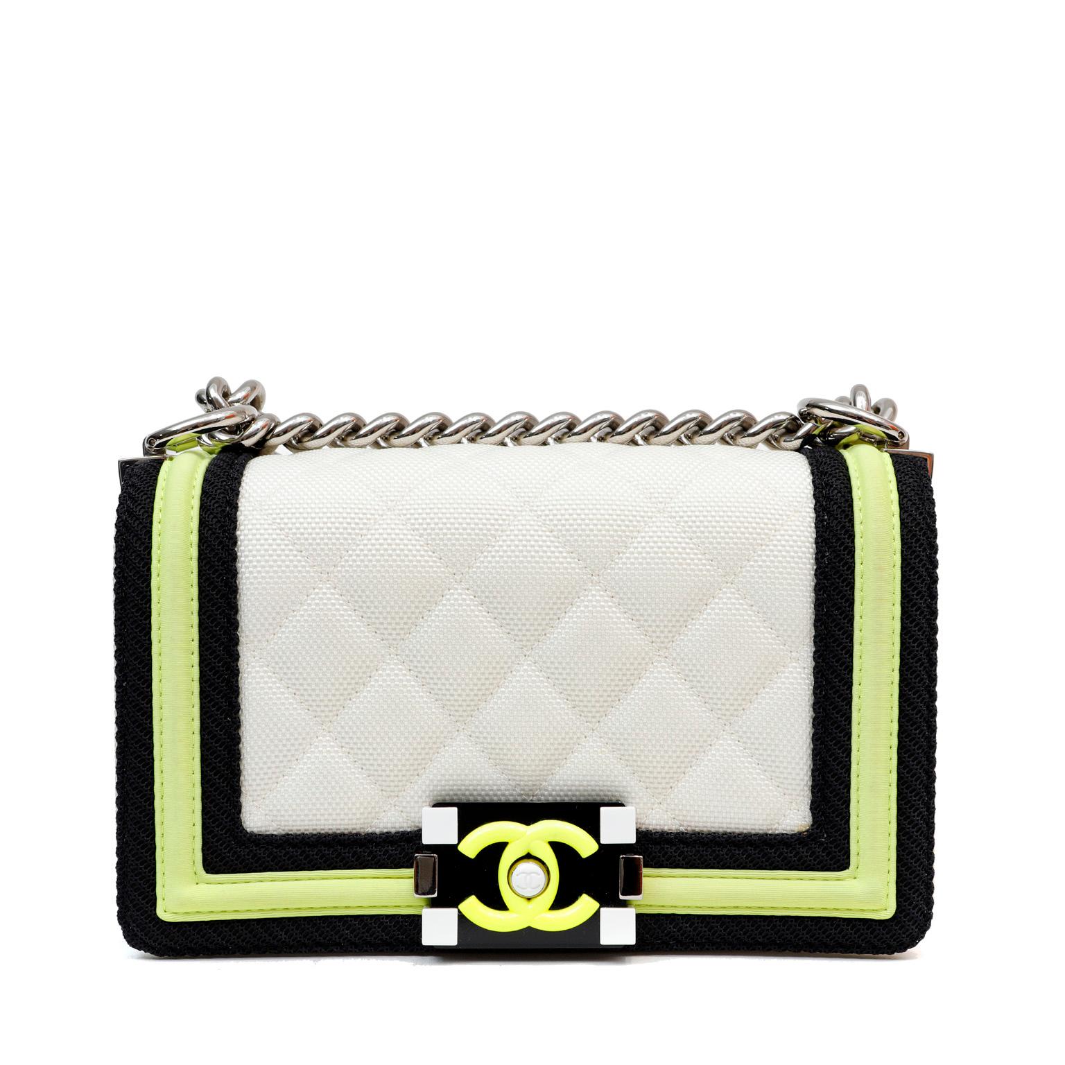 This authentic Chanel White Canvas Fluo Flap Boy Bag is in pristine condition. The updated design is structured and edgy with a versatility that makes it extremely popular.  The canvas Fluo Flap version takes details a step further with neon pops of