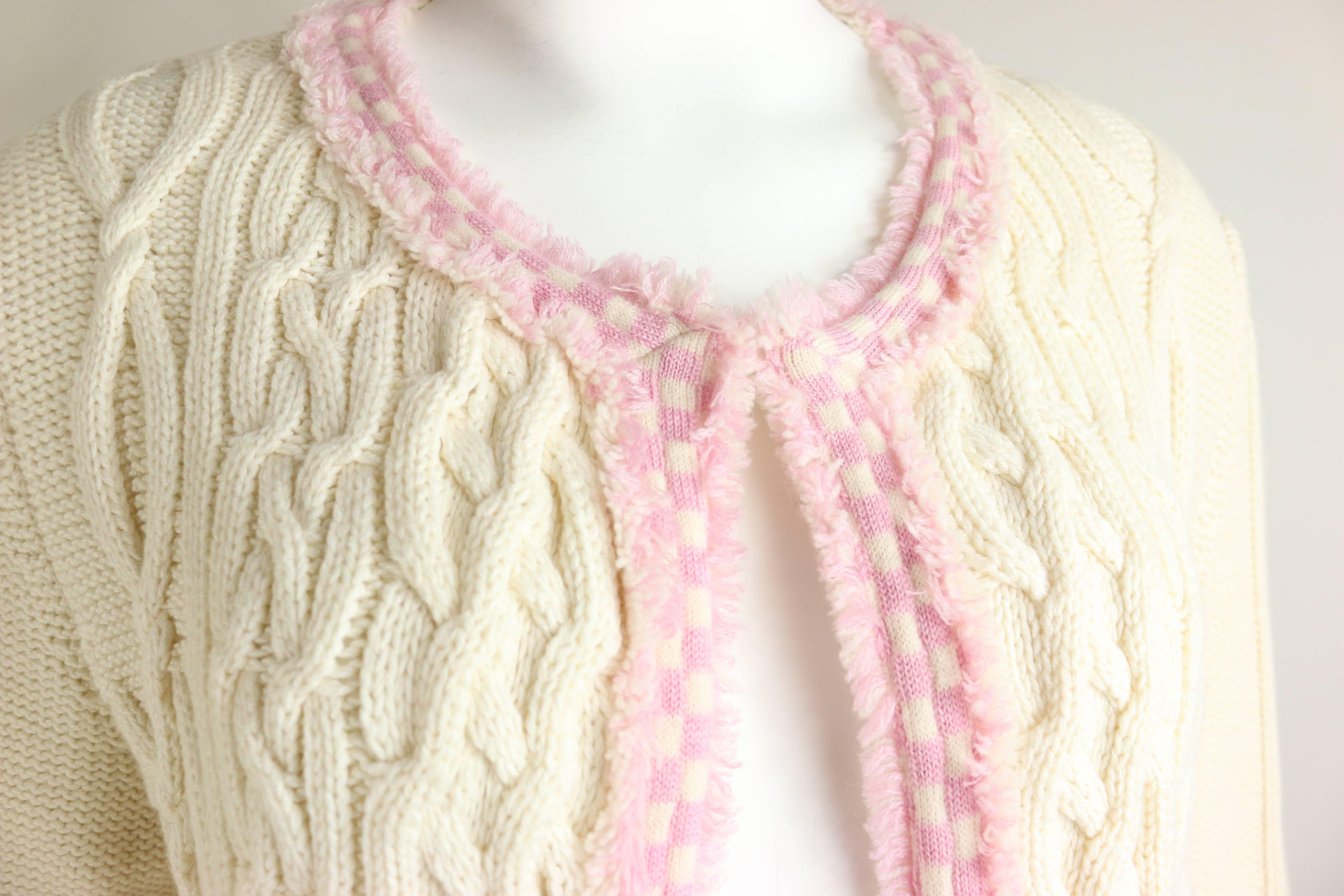 - Chanel white heavy cashmere/cotton knitted pink fringe trim cardigan sweater from 2005 spring /summer collection.  

- Featuring no front closure and two front fringe trim pockets. 

- Made in France. 

- Size 42 

- 65% Cashmere, 35% Cotton. 