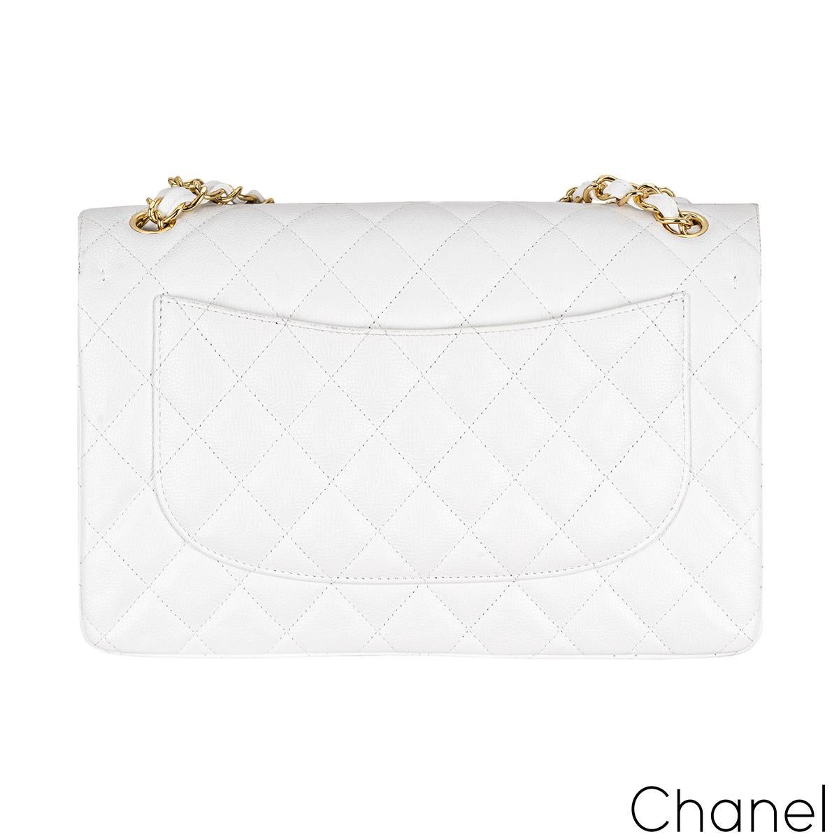 A gorgeous Chanel Jumbo Classic Double Flap Handbag. The exterior of this jumbo classic is in white caviar quilted leather with gold-tone hardware. It features a front flap with signature CC turnlock closure, half moon back pocket, and an adjustable