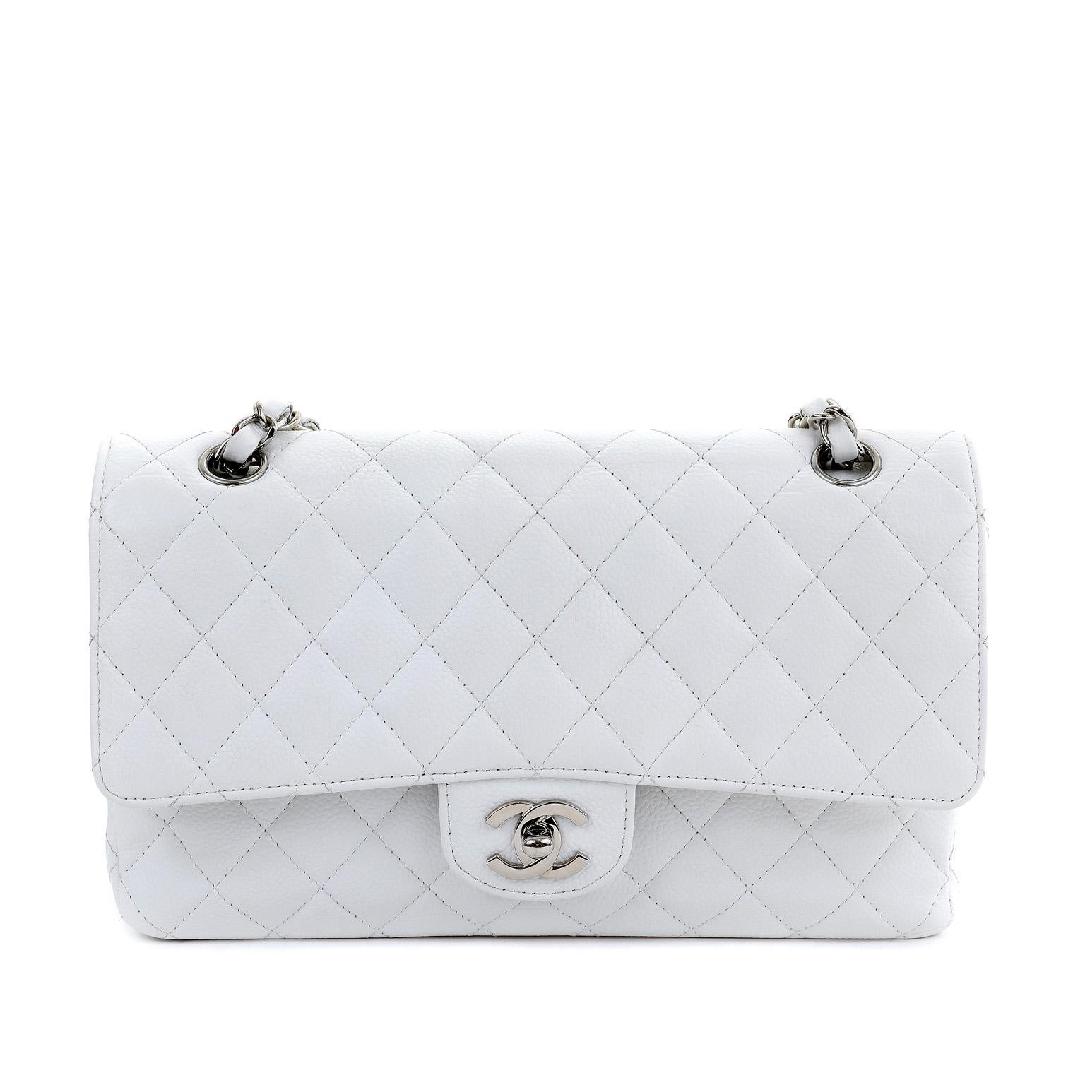 This authentic Chanel White Caviar Leather Medium Classic Flap Bag is in pristine condition.  A key piece in any sophisticated wardrobe, the Classic Flap is one of the most sought-after Chanel styles produced. 
Durable and textured snowy white
